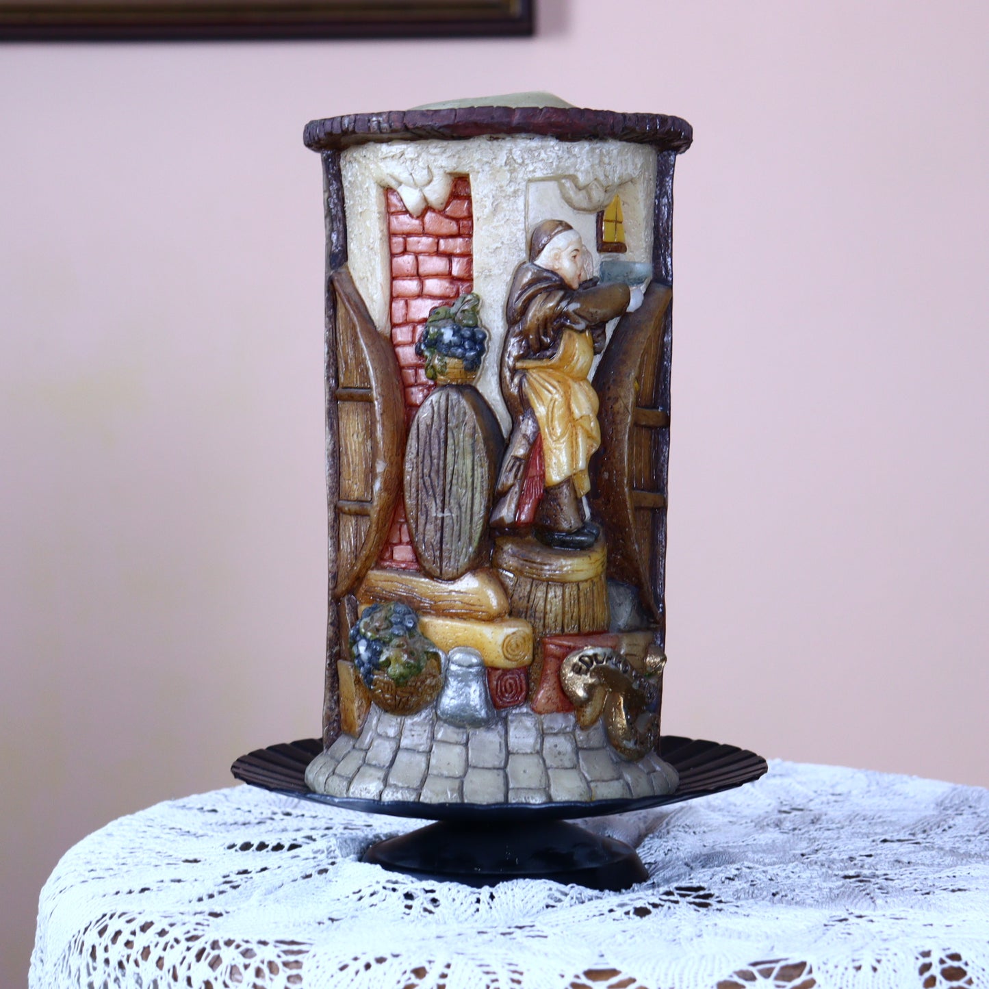 Old hand-made candle decorated with funny figures of monks