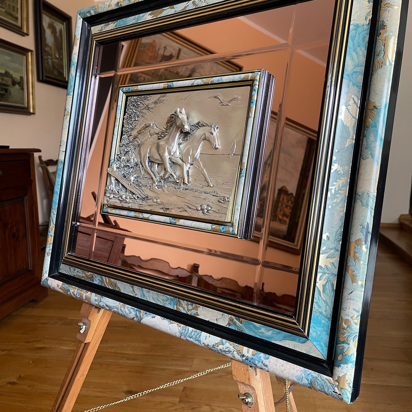 Decorative mirror with a horse design on a wooden easel