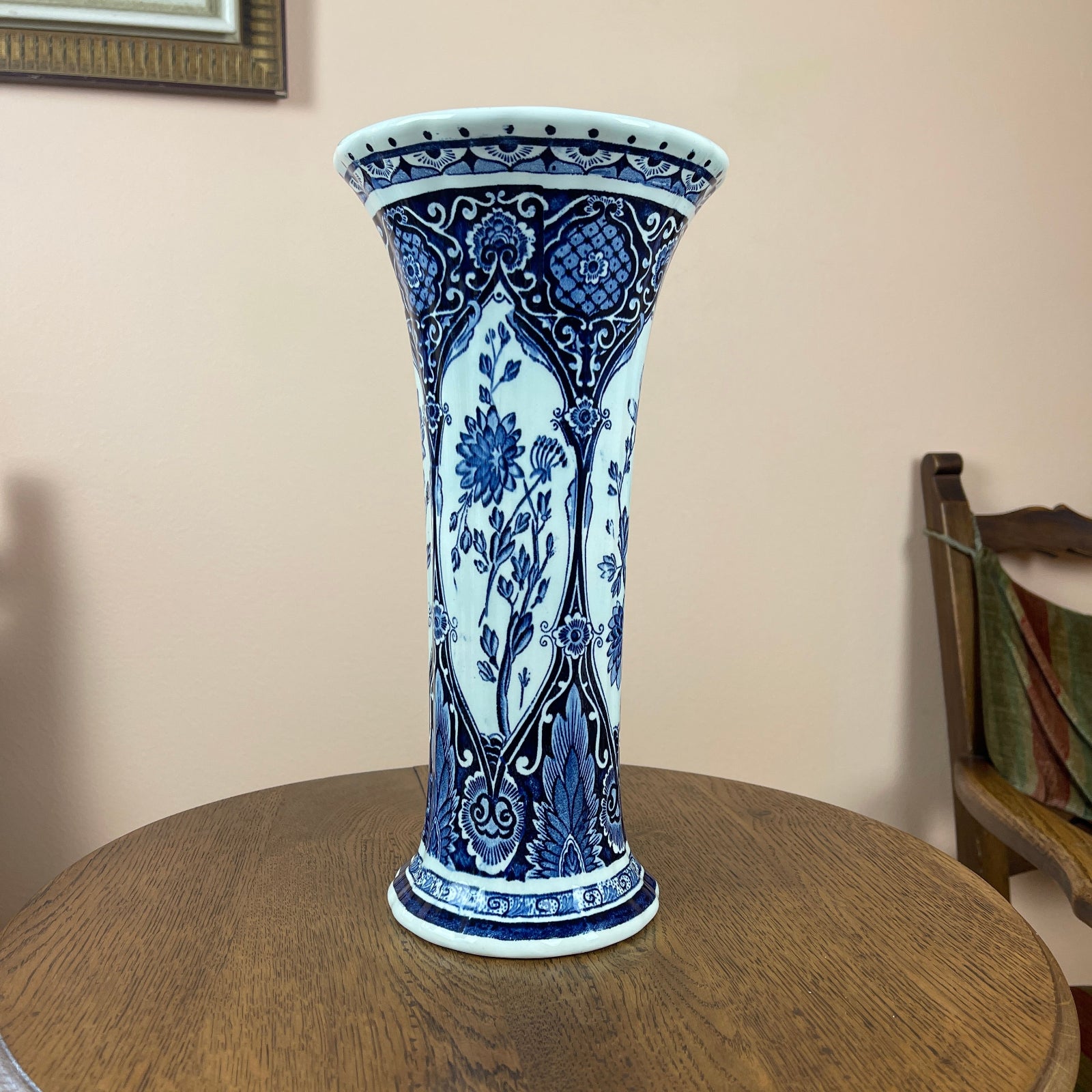 Blue and white decorative vase on a wooden table with a neutral background