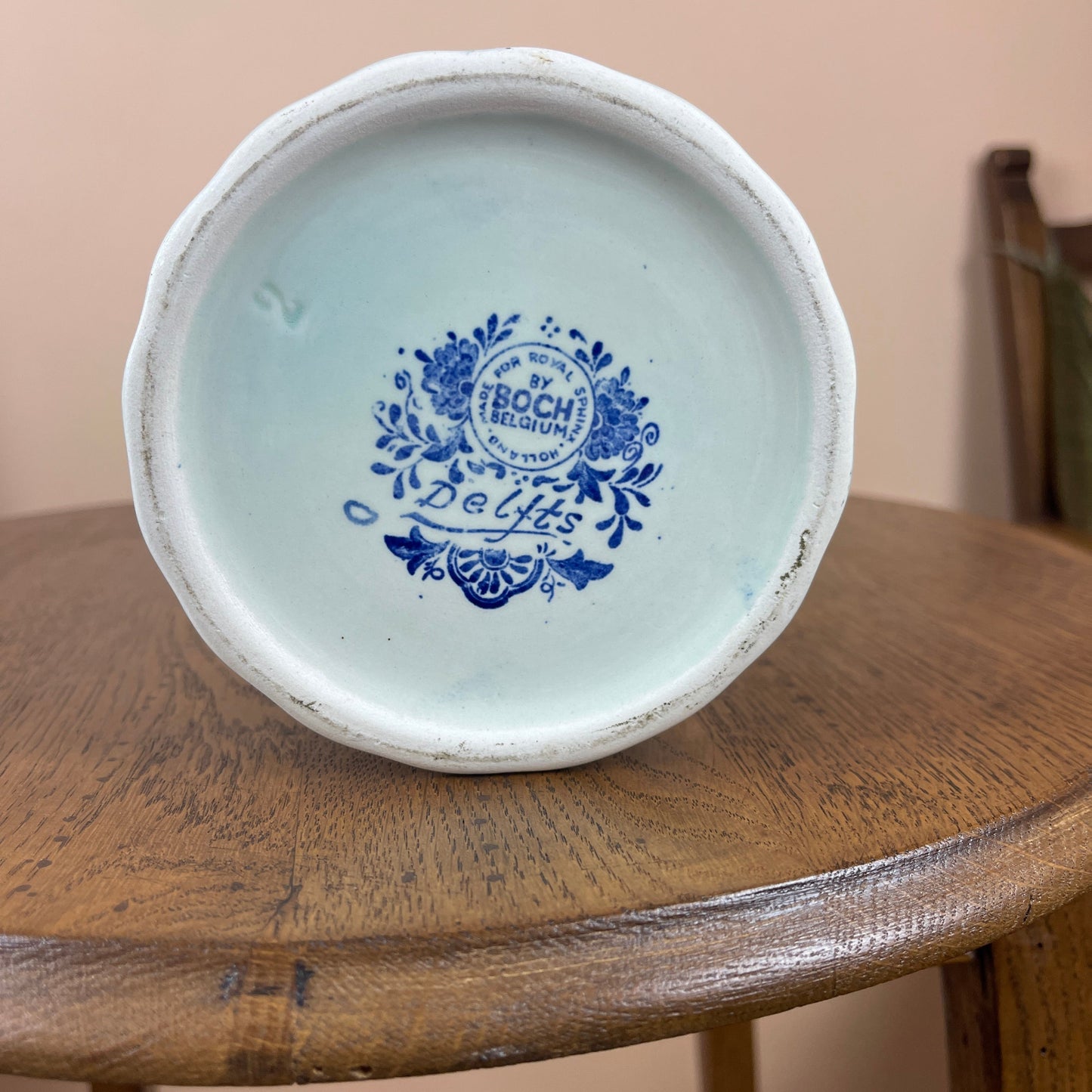 Vintage ceramic bowl with blue floral design on a wooden surface