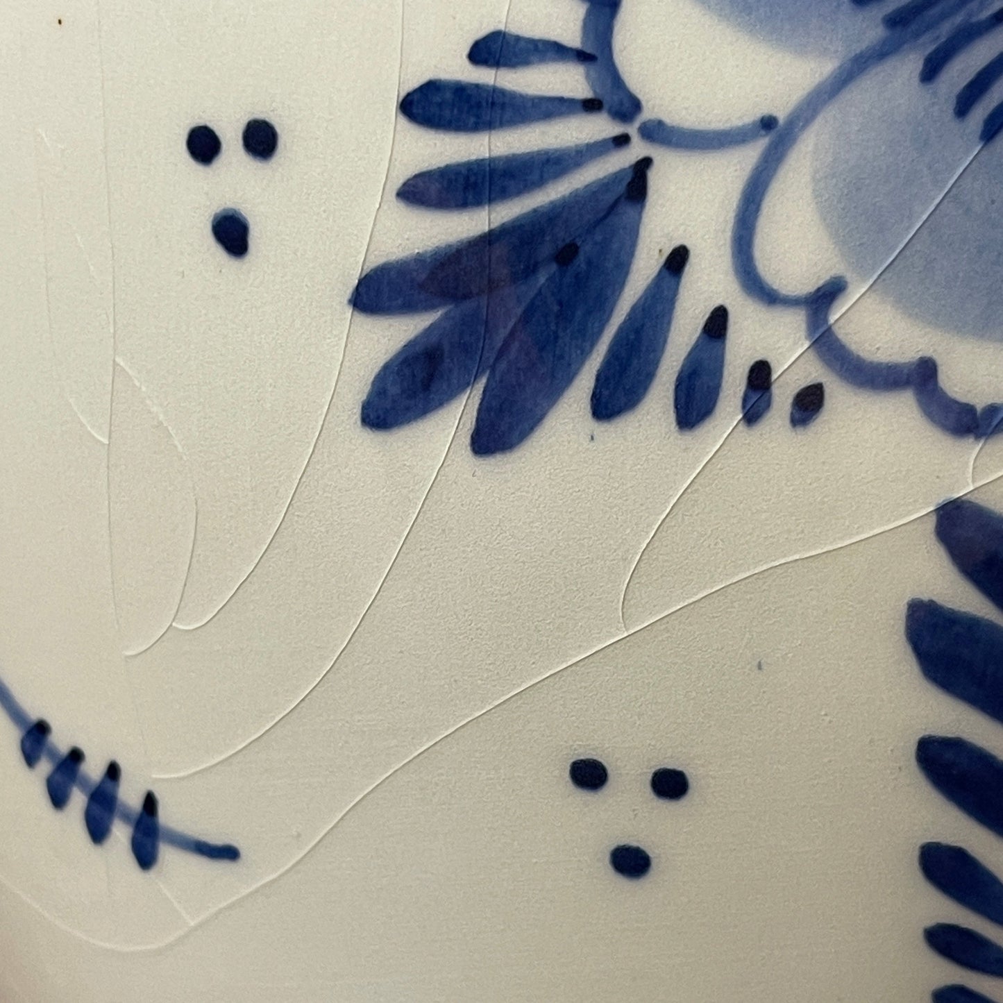 Close-up of blue floral pattern on a ceramic tile