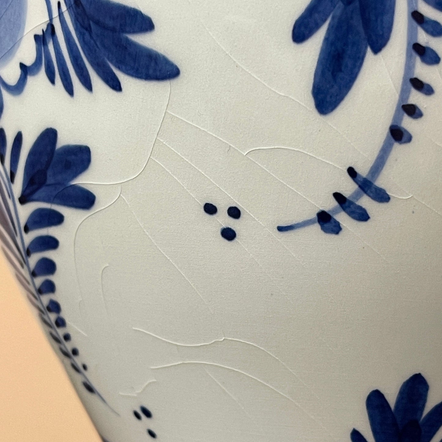 Close-up of a ceramic vase with blue floral patterns on a white background