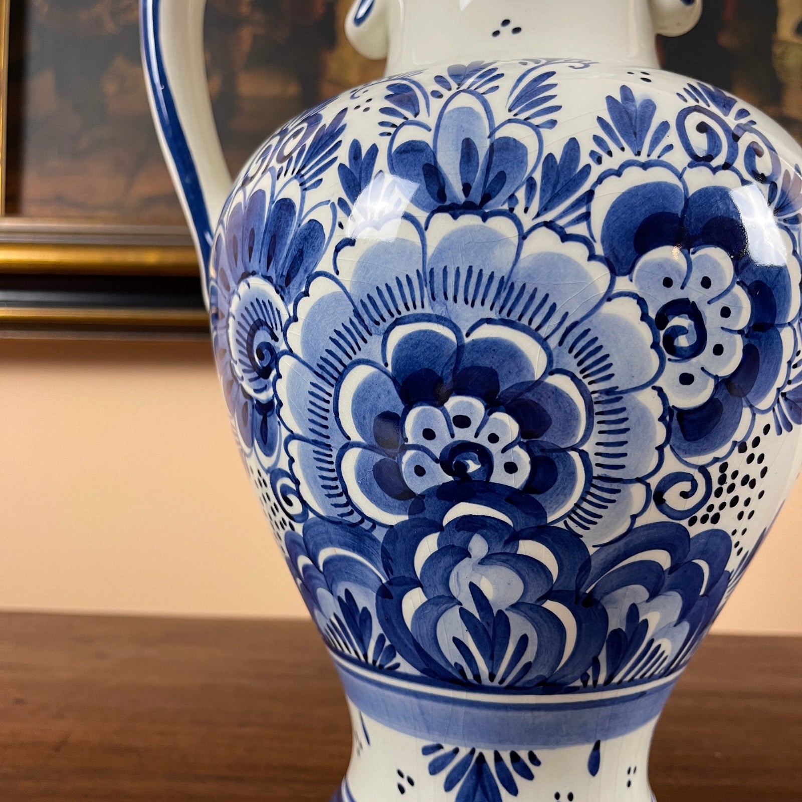 Blue and white floral patterned vase on a wooden surface with a blurred background