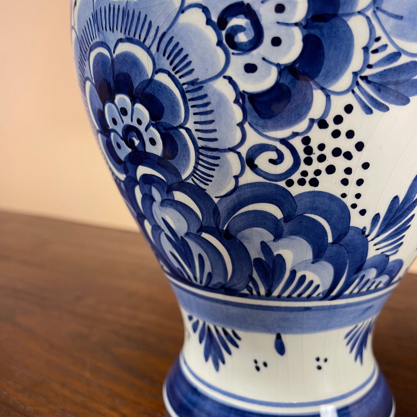 Blue and white floral patterned vase on a wooden surface