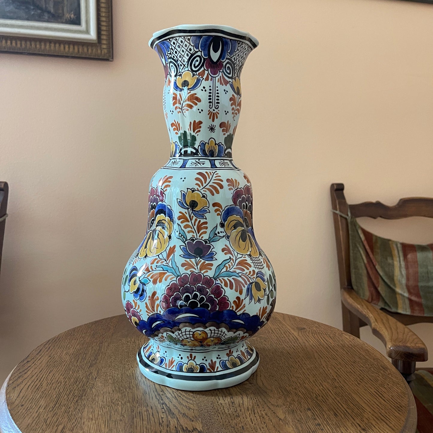 Decorative ceramic vase with floral patterns on a wooden table.