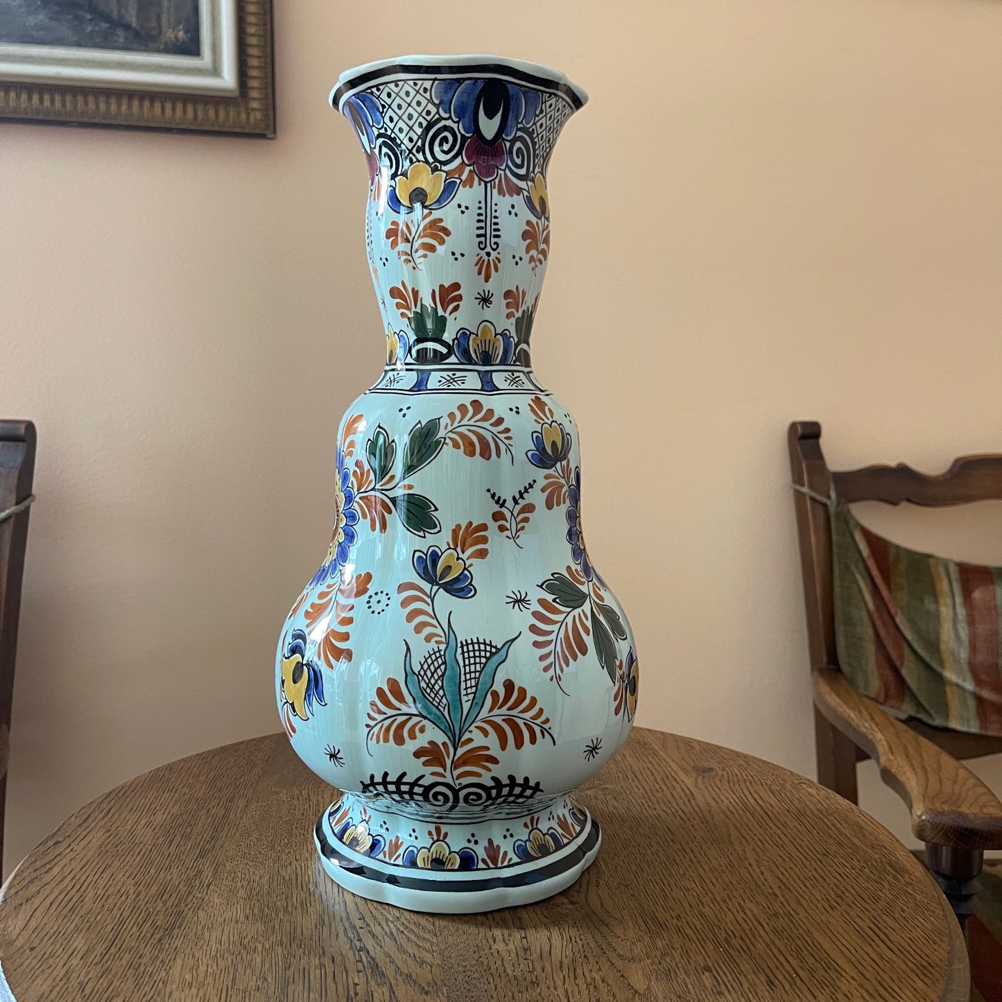 Decorative ceramic vase with floral patterns on a wooden table
