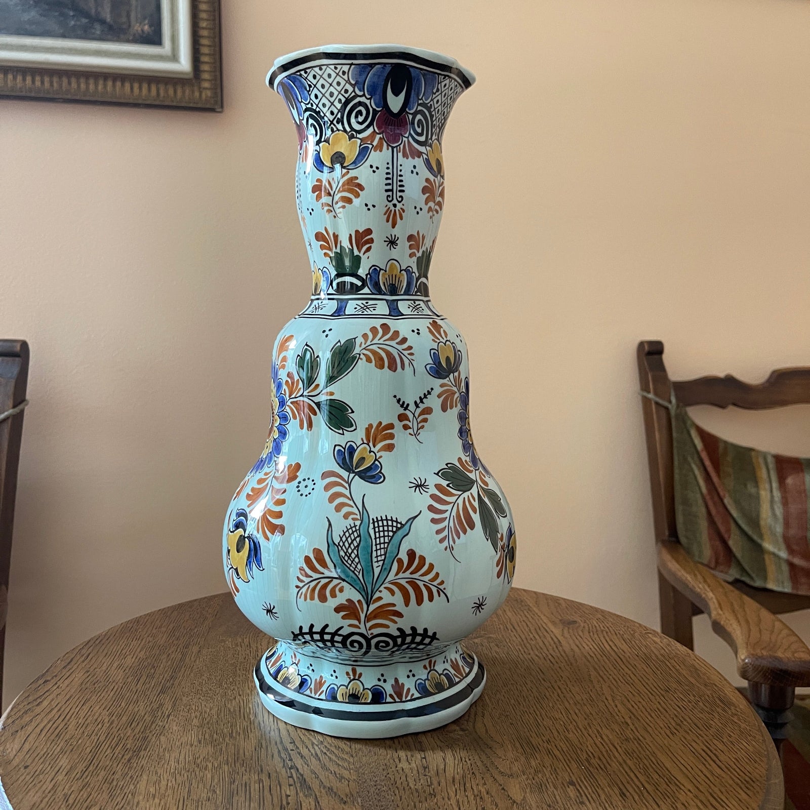 Decorative ceramic vase with floral patterns on a wooden table