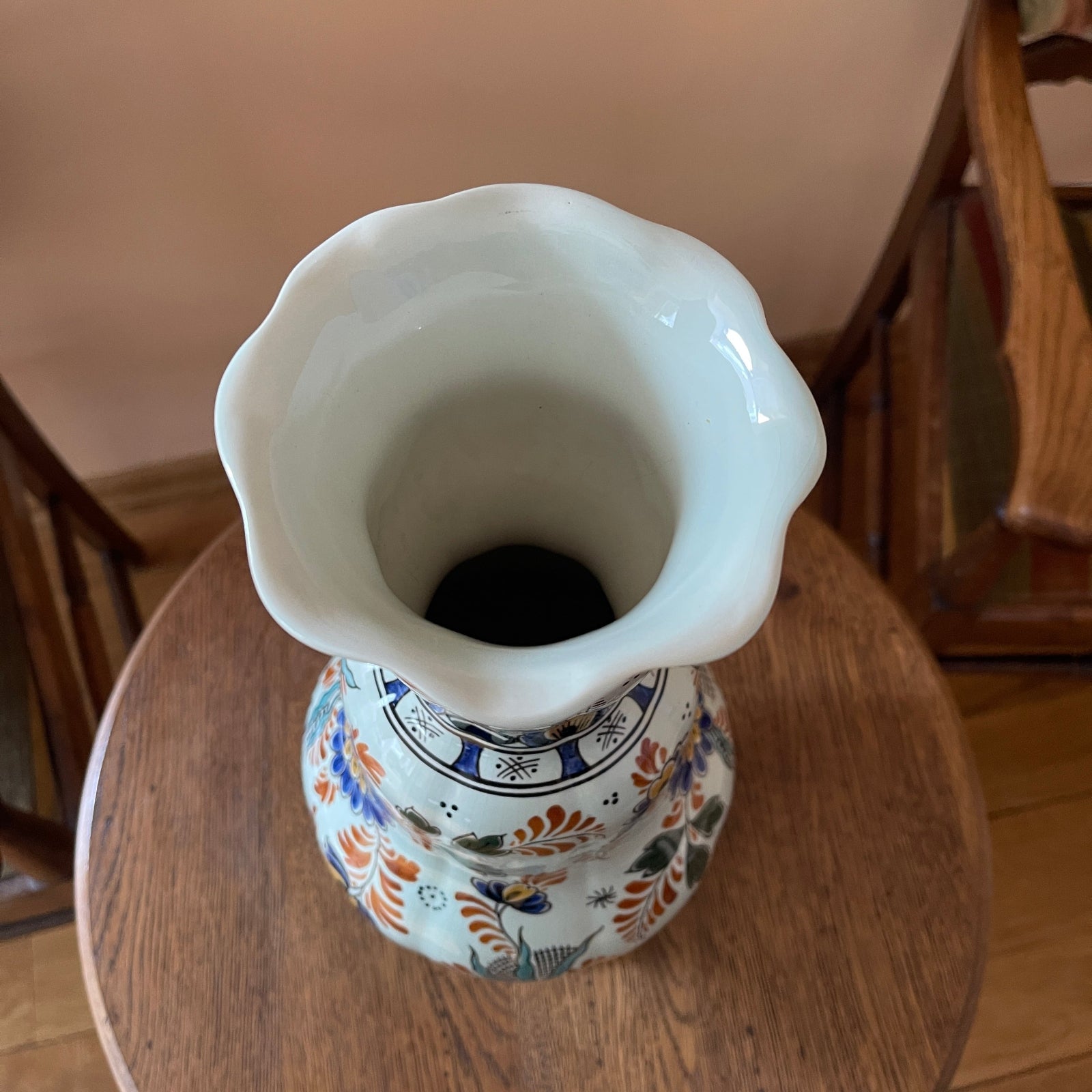 Decorative ceramic vase with floral patterns on a wooden surface