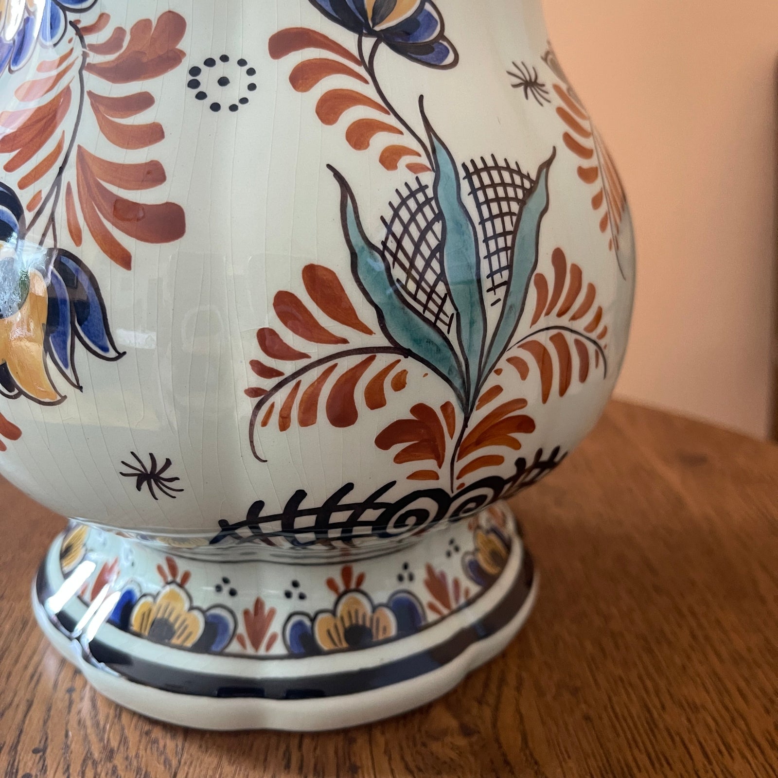 Decorative ceramic vase with floral patterns on a wooden surface