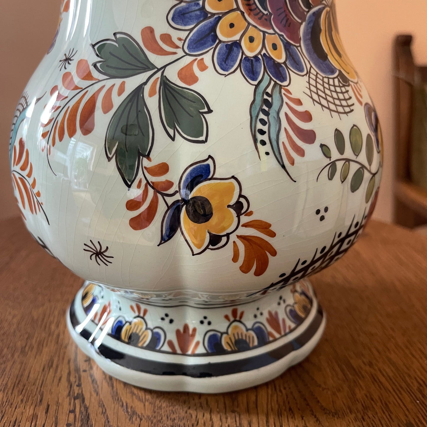 Decorative ceramic vase with floral patterns on a wooden surface