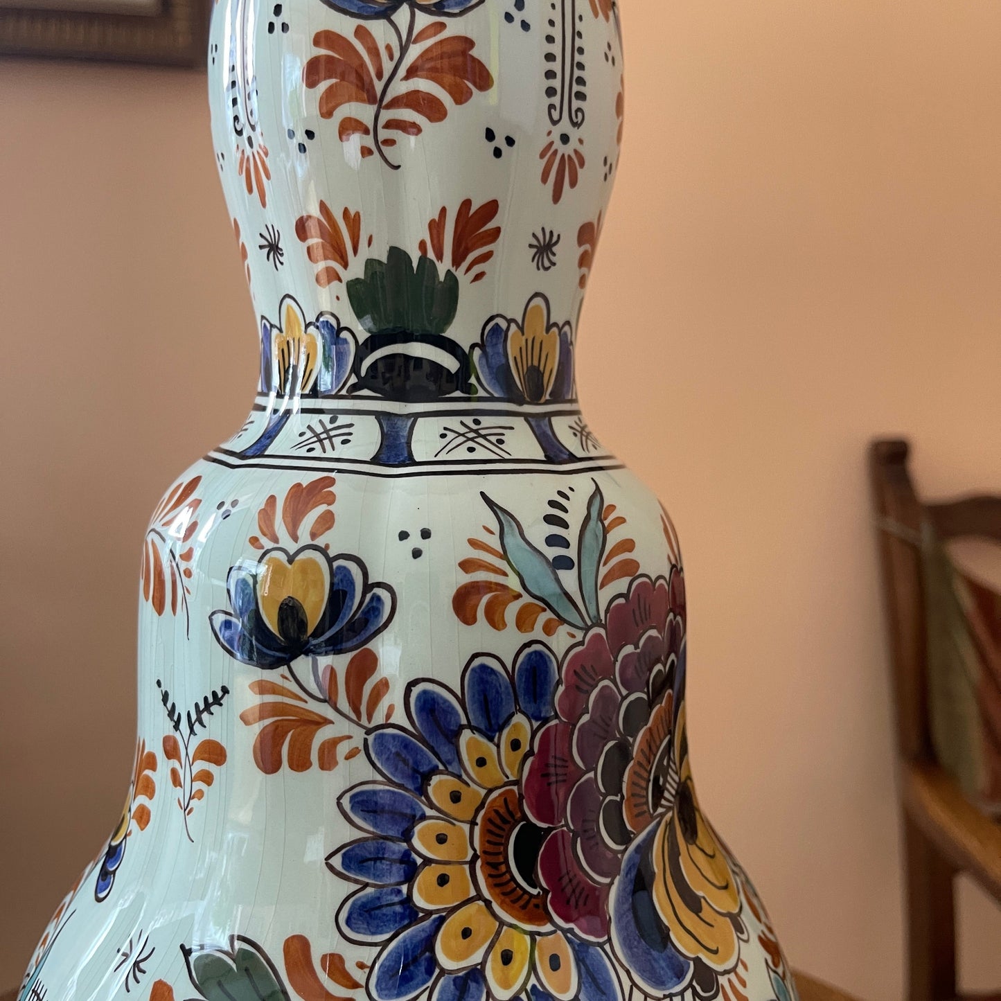 Decorative ceramic vase with colorful floral patterns on a blurred background