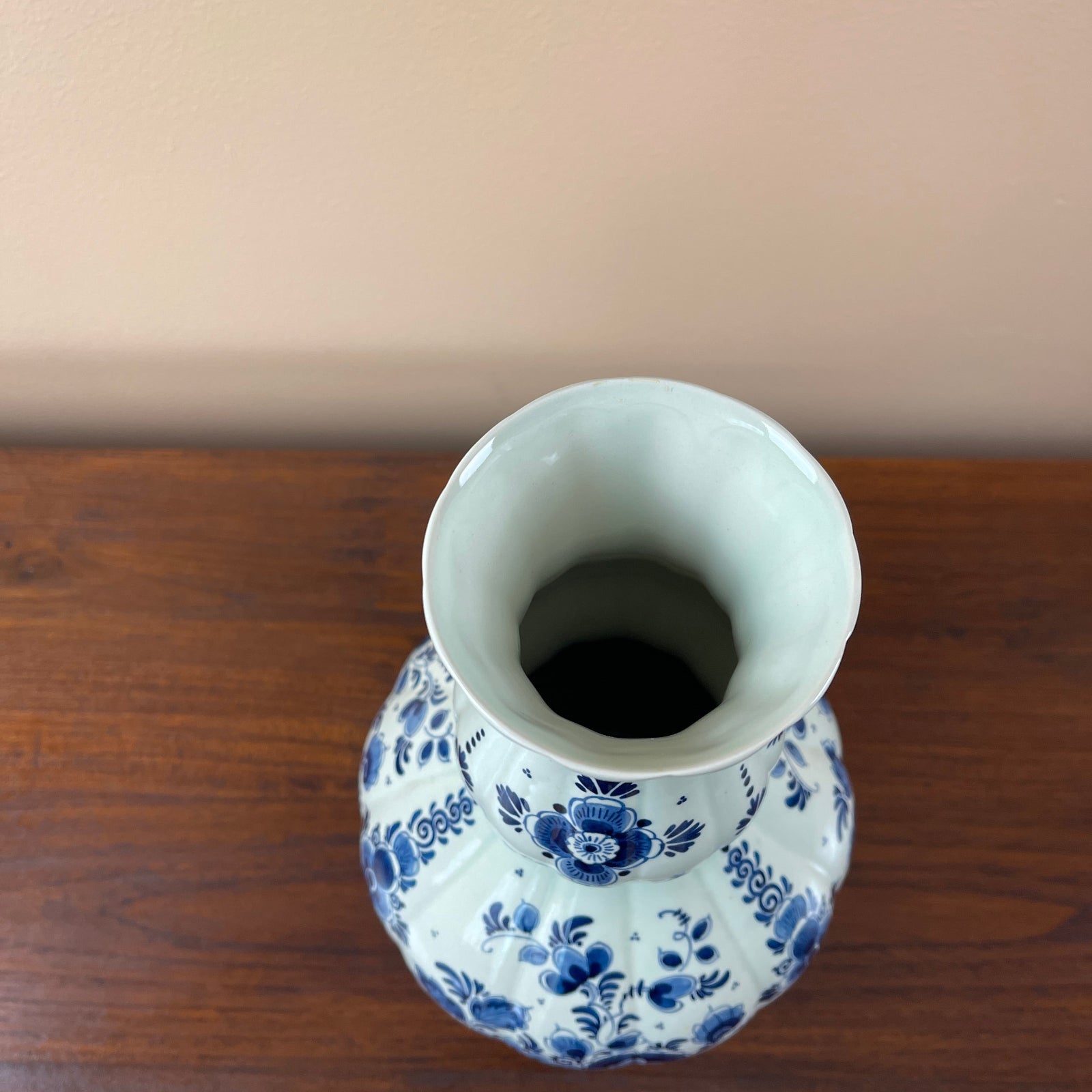 White vase with blue floral patterns on a wooden surface