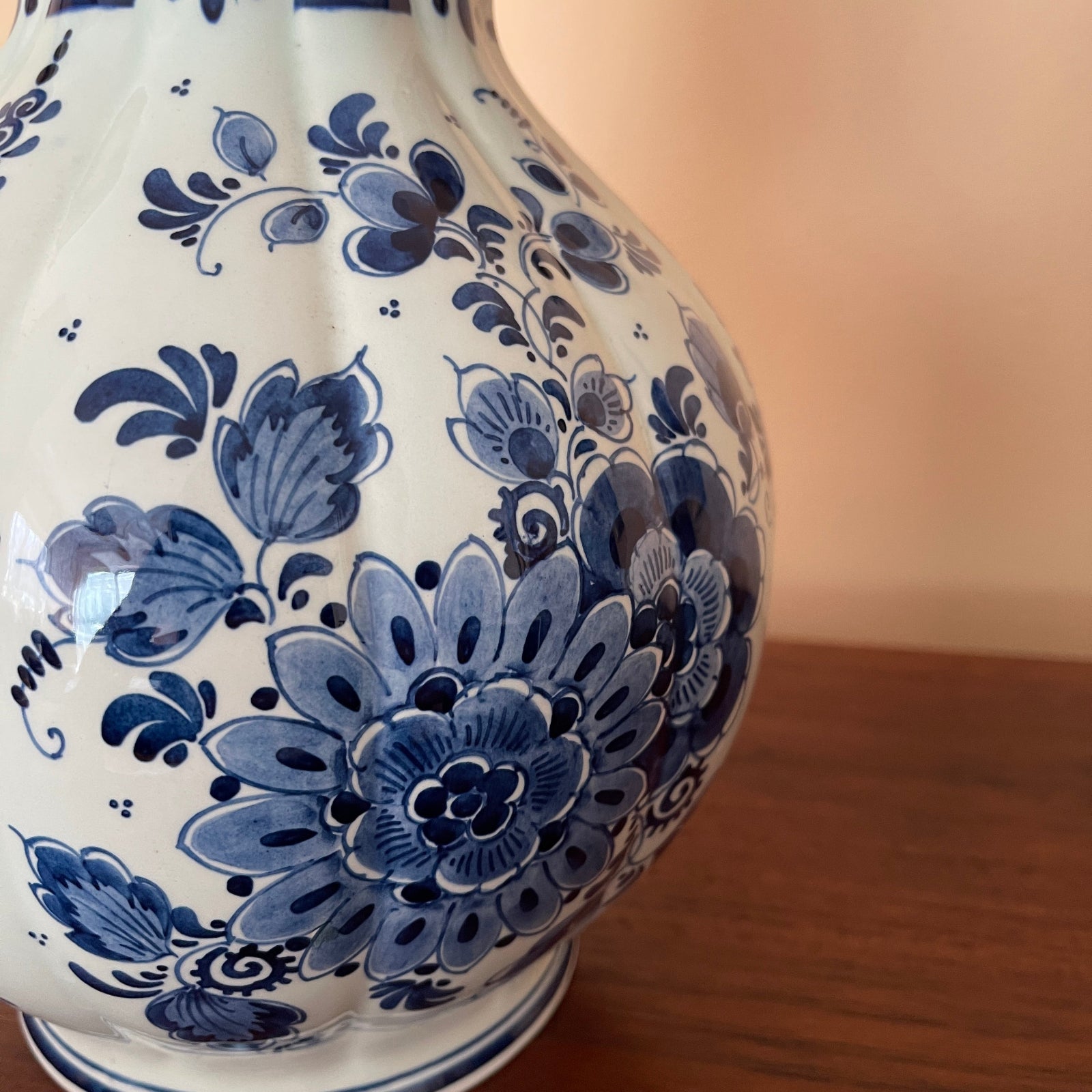 Ceramic vase with blue floral patterns on a wooden surface