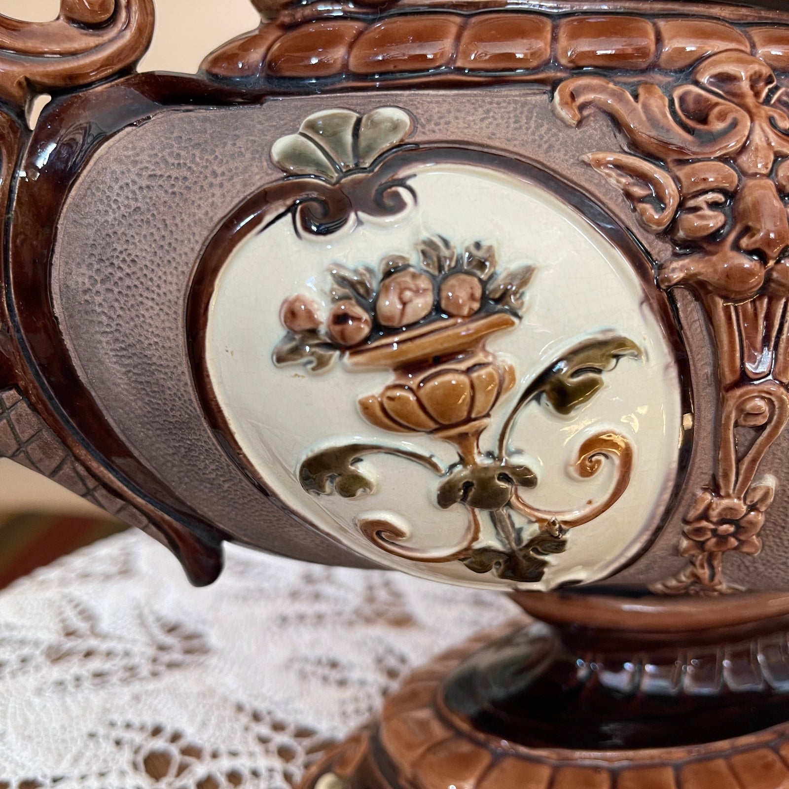 Decorative ceramic piece with floral design on a textured surface