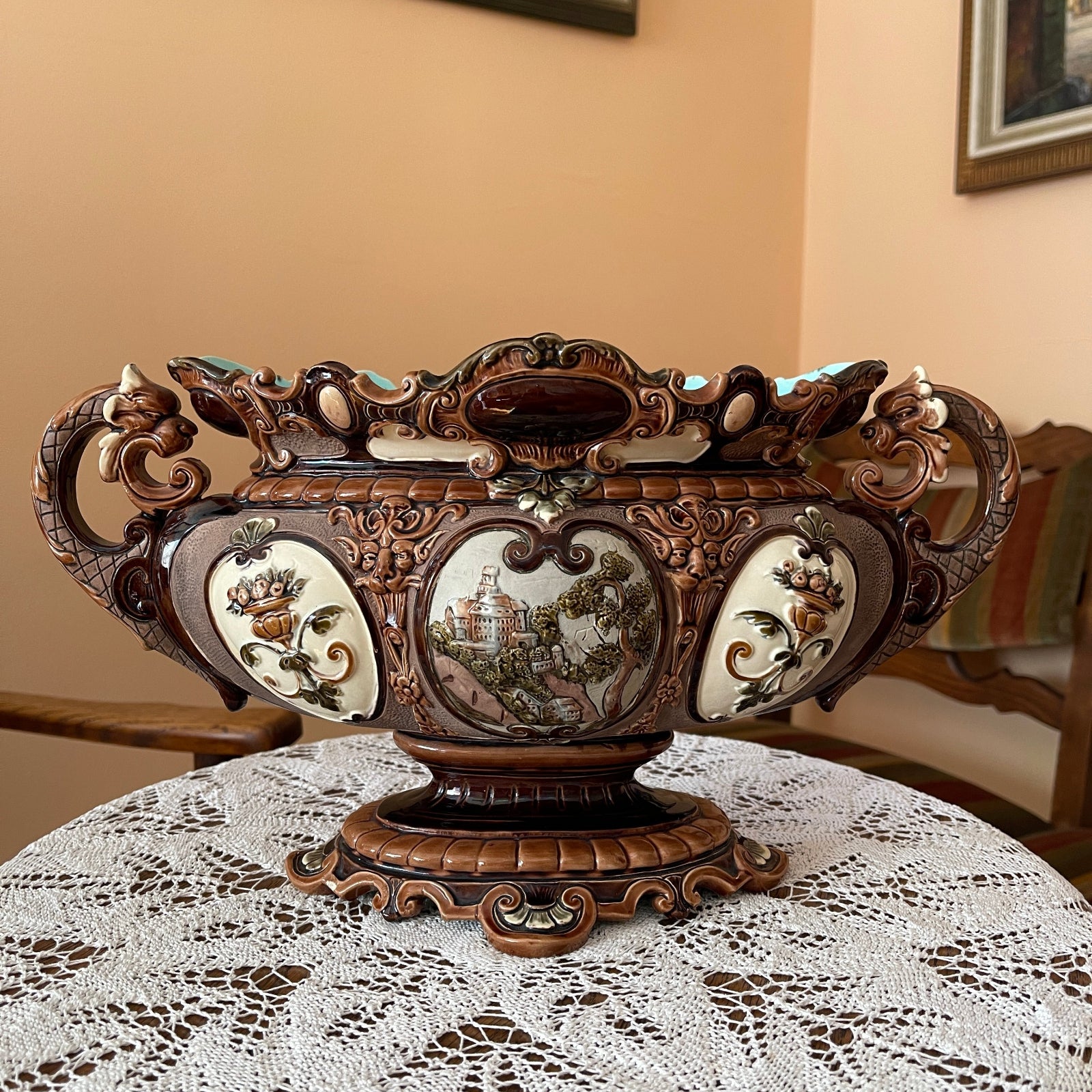 Decorative ornate bowl on a lace tablecloth with a neutral background