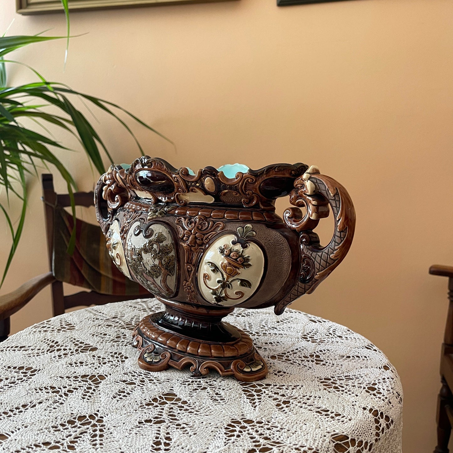 Decorative vase with floral patterns on a lace tablecloth