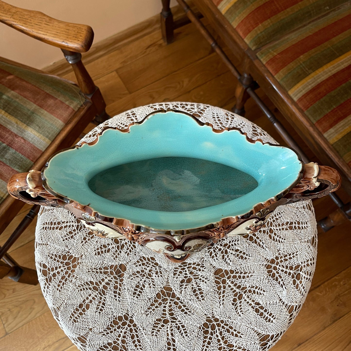 Decorative ceramic bowl with lace-like design on a wooden chair