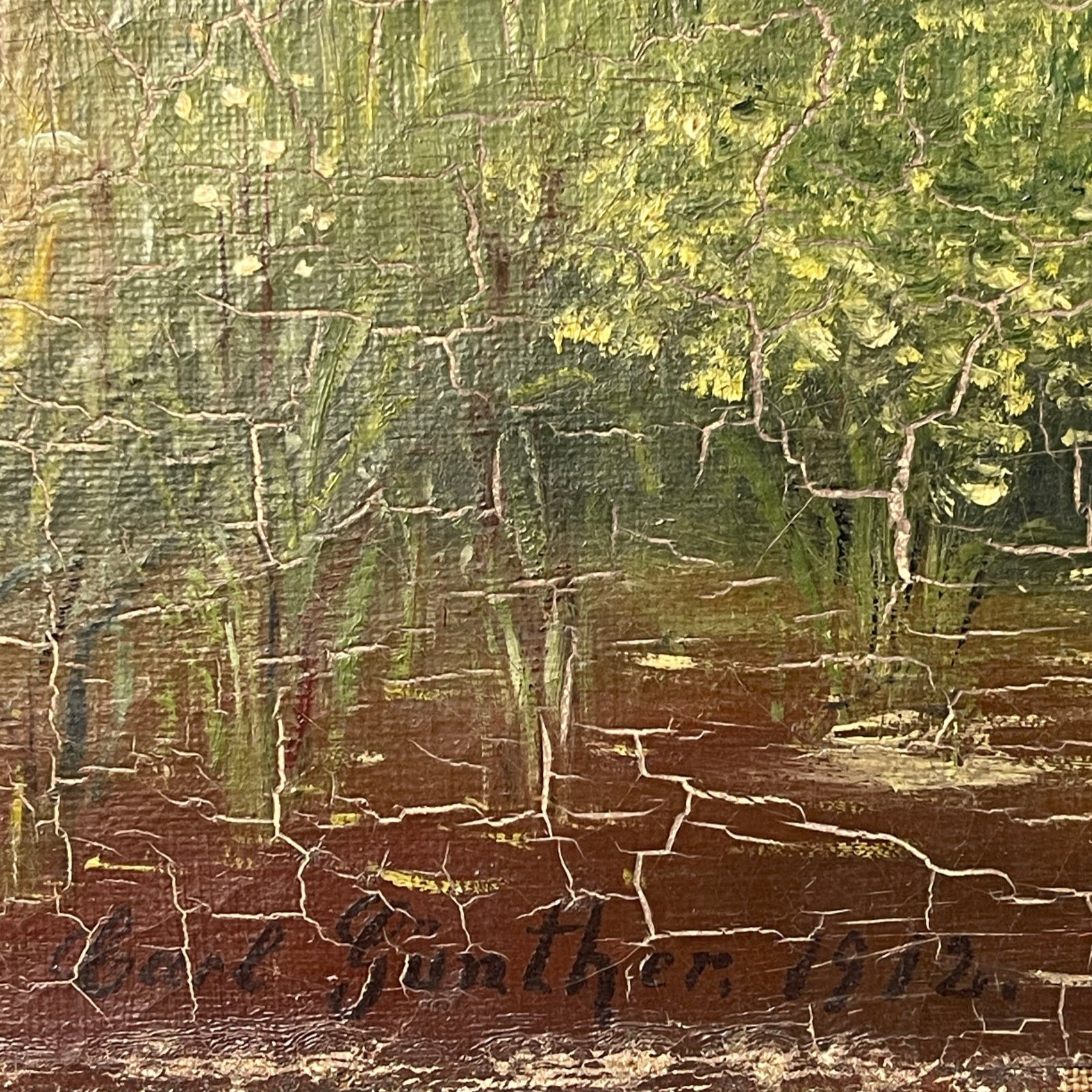 Close-up of a textured painting with visible signature at the bottom.