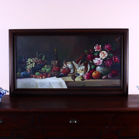 A framed oil painting on canvas depicting a still life scene with a pheasant, fruits, and flowers, set against a pale background.