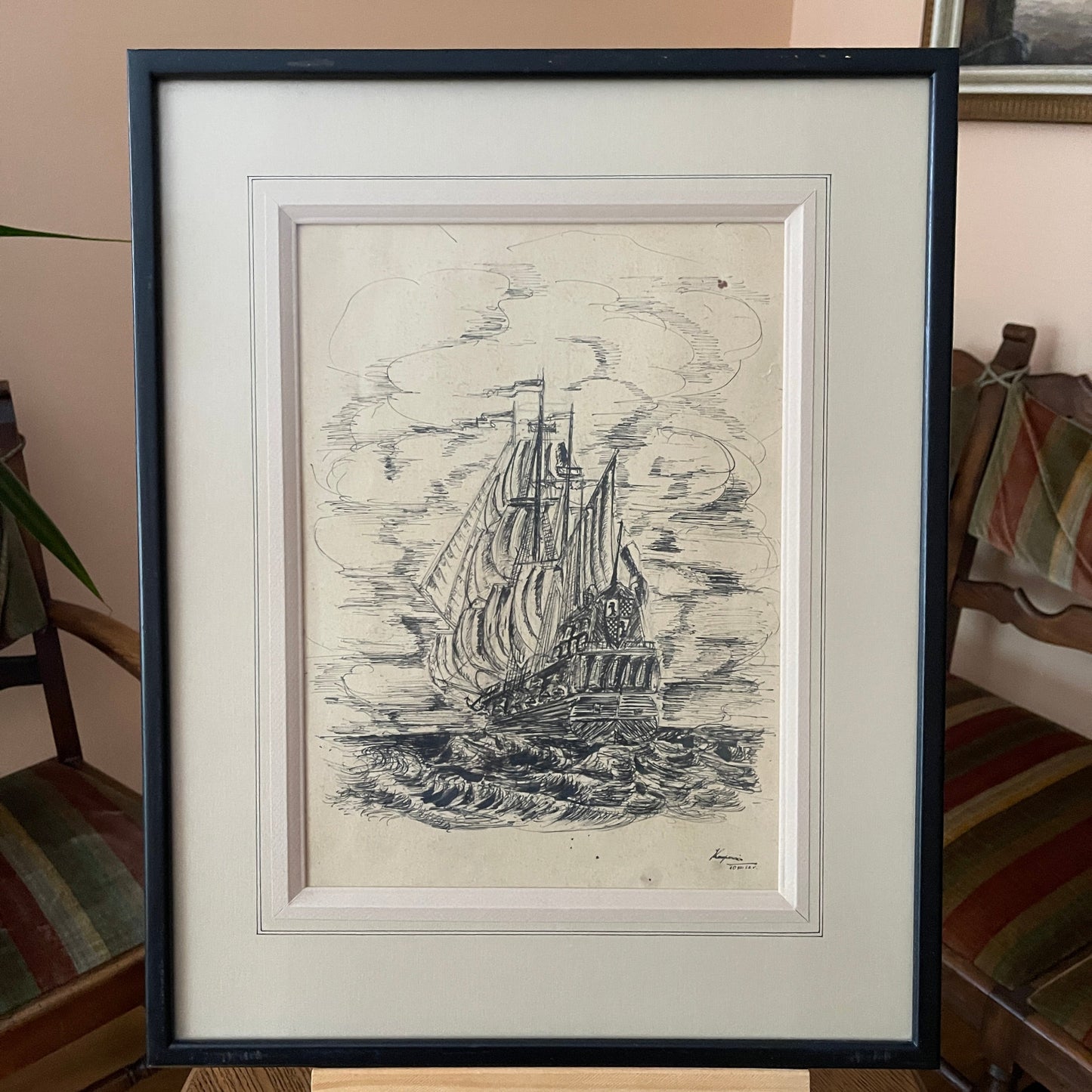 Framed black and white ship illustration on a neutral background