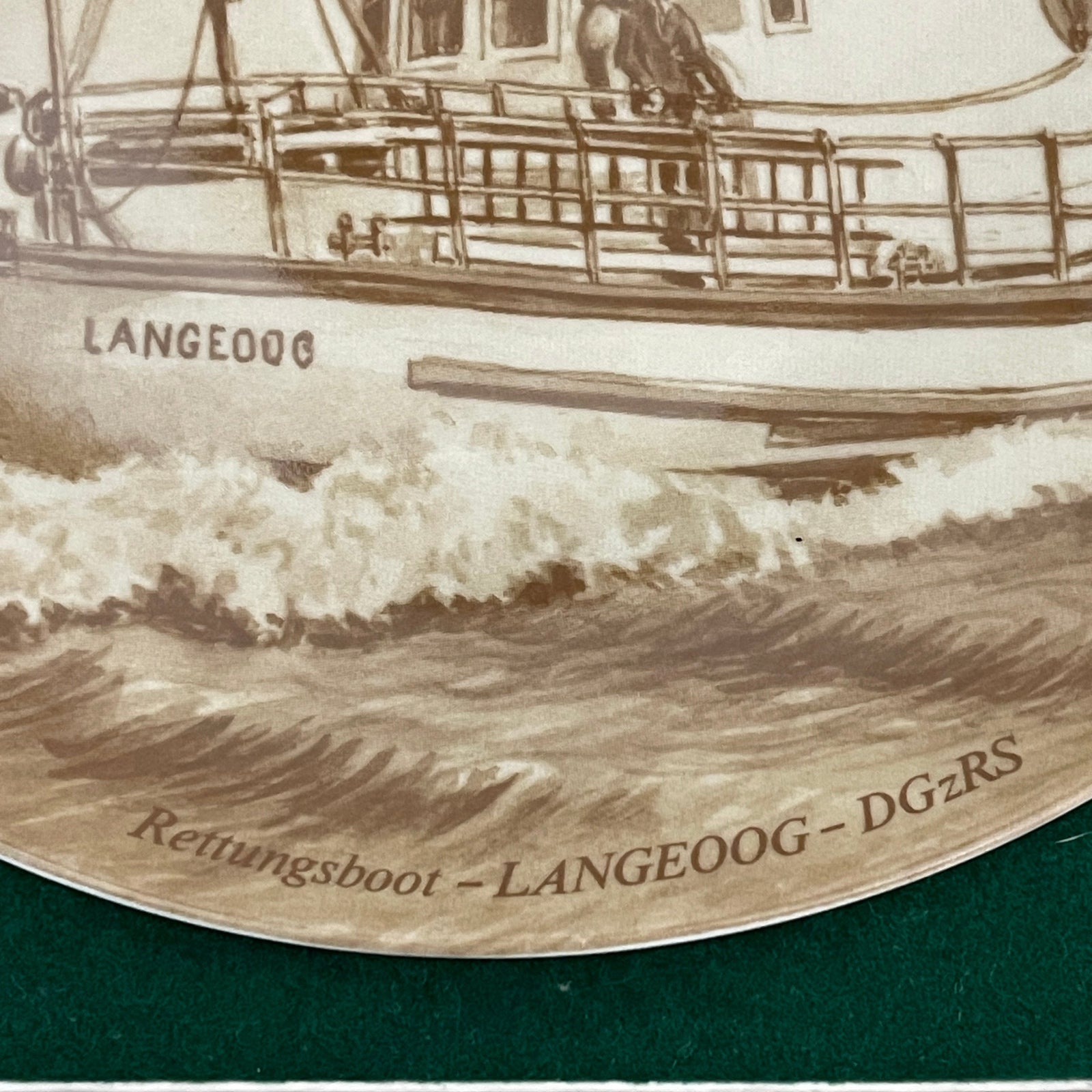 Engraved plate of a lifeboat with 'LANGEOOG' and 'Rettungsboot - LANGEOOG - DGzRS' text.
