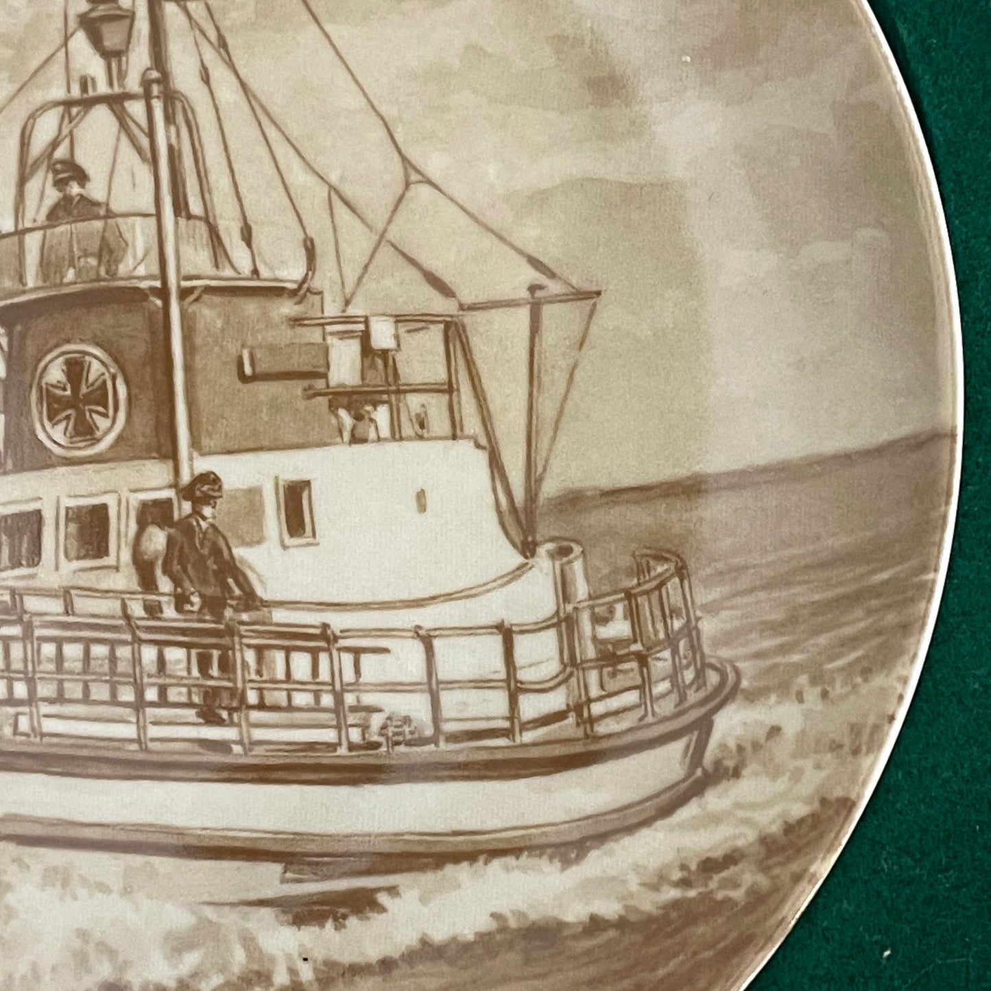 Engraved plate with a detailed illustration of a boat on water