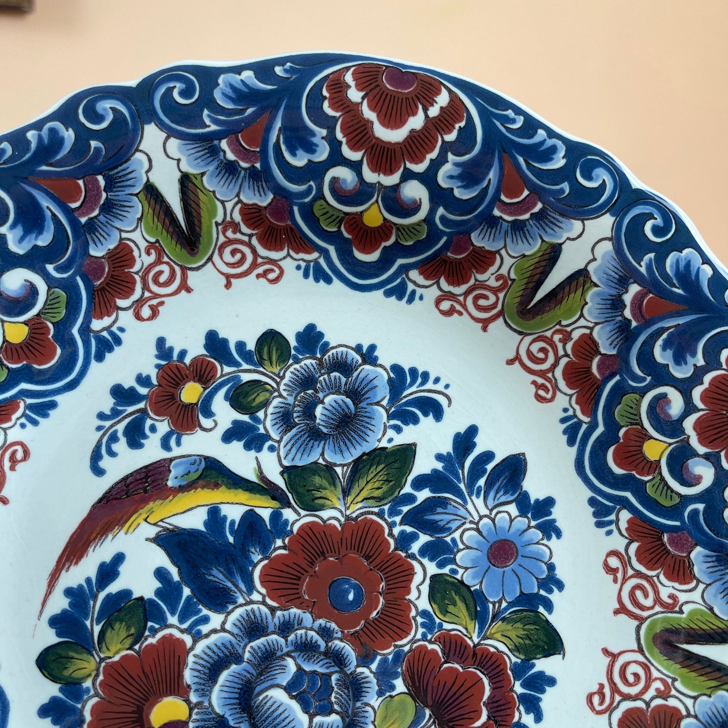 Decorative plate with floral and bird pattern on a beige background