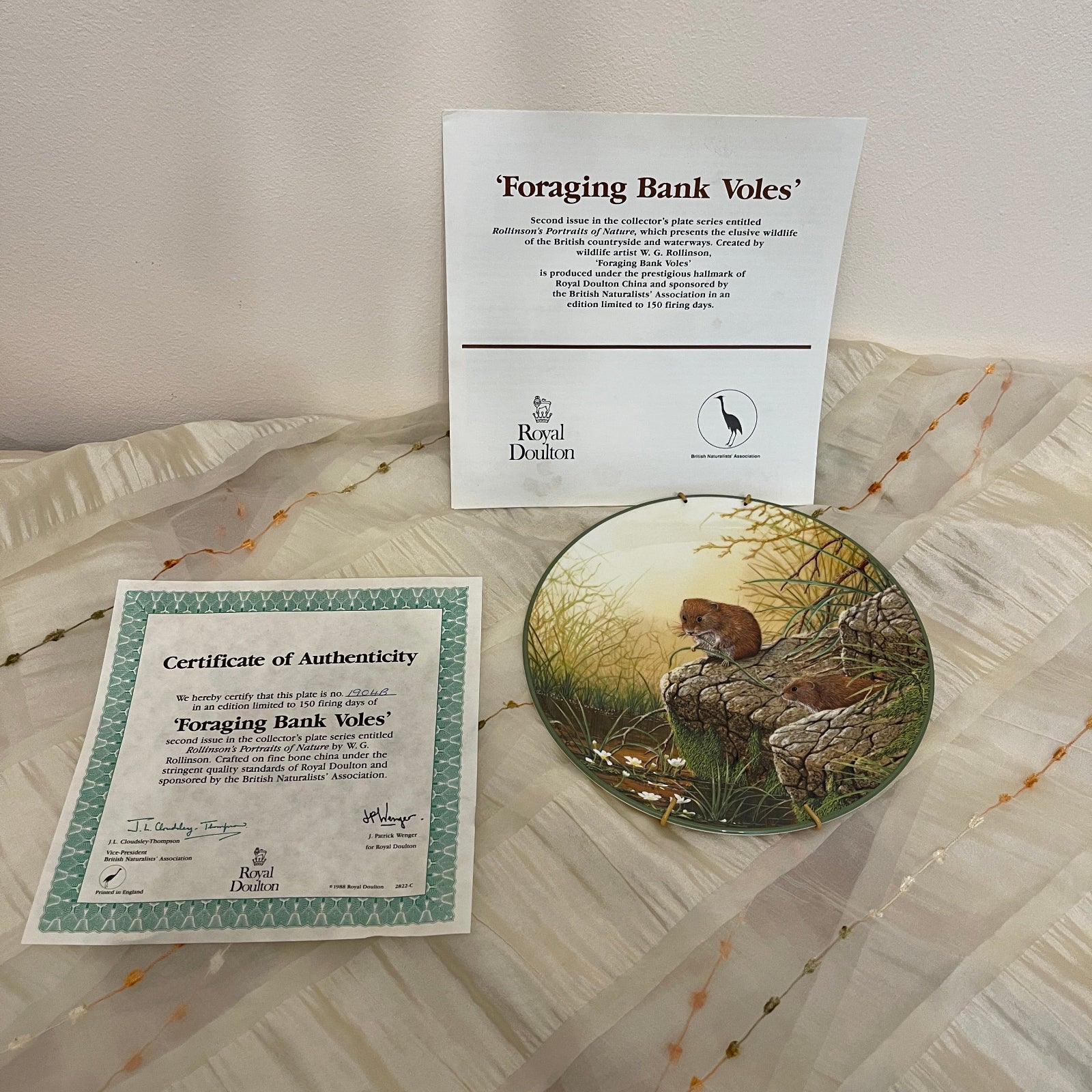 Royal Doulton 'Foraging Bank Voles' plate with certificate of authenticity on a textured surface