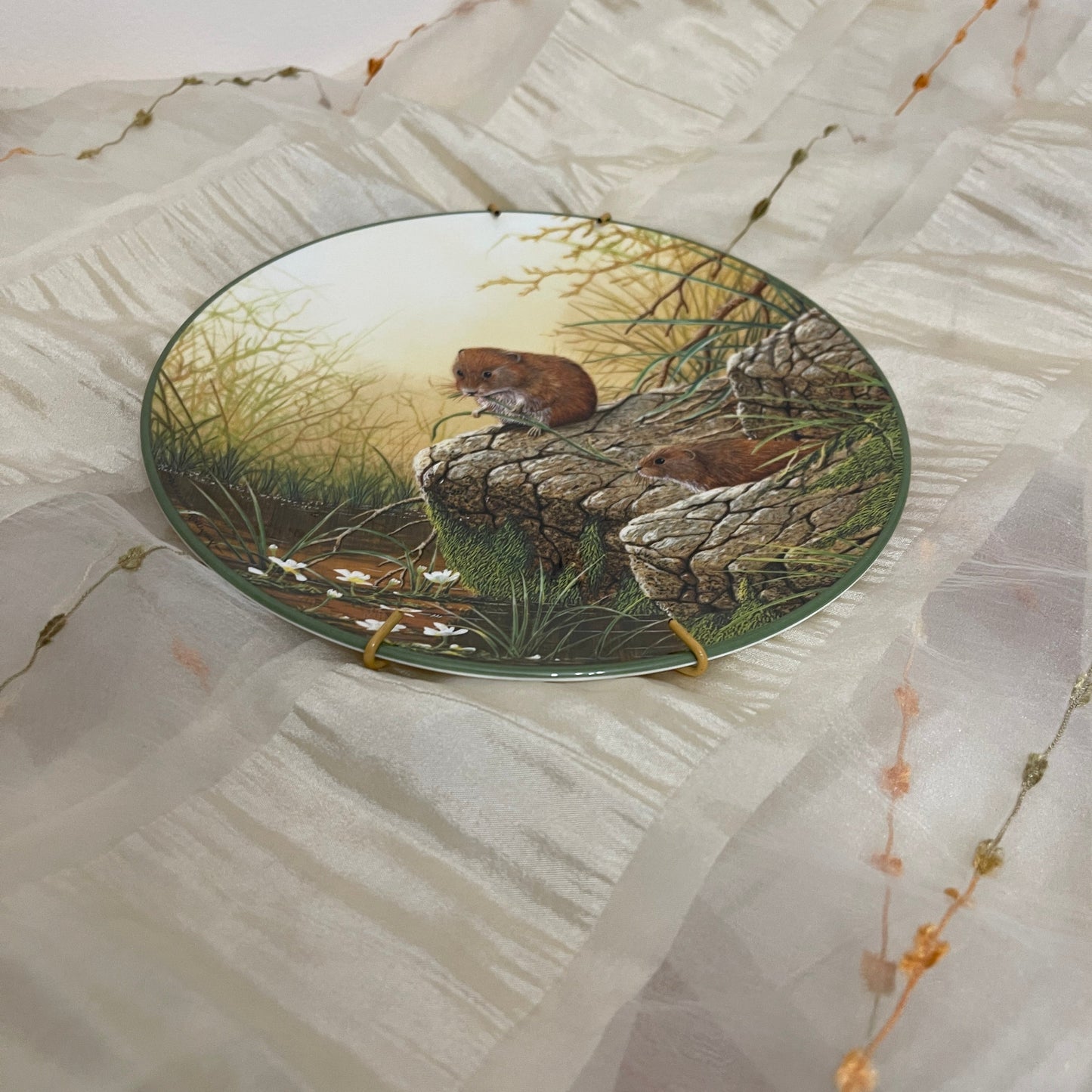 Decorative plate with nature-themed design on a textured surface