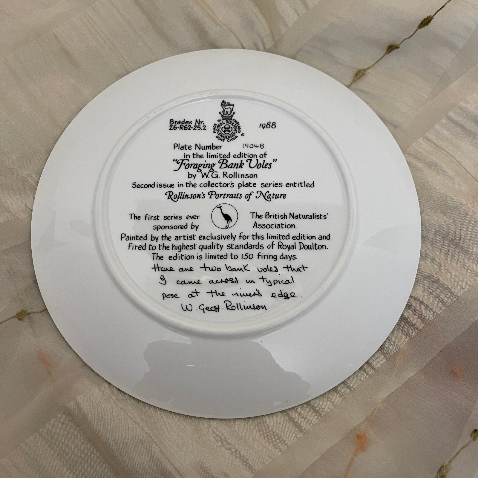 White plate with black text and a logo on a textured surface