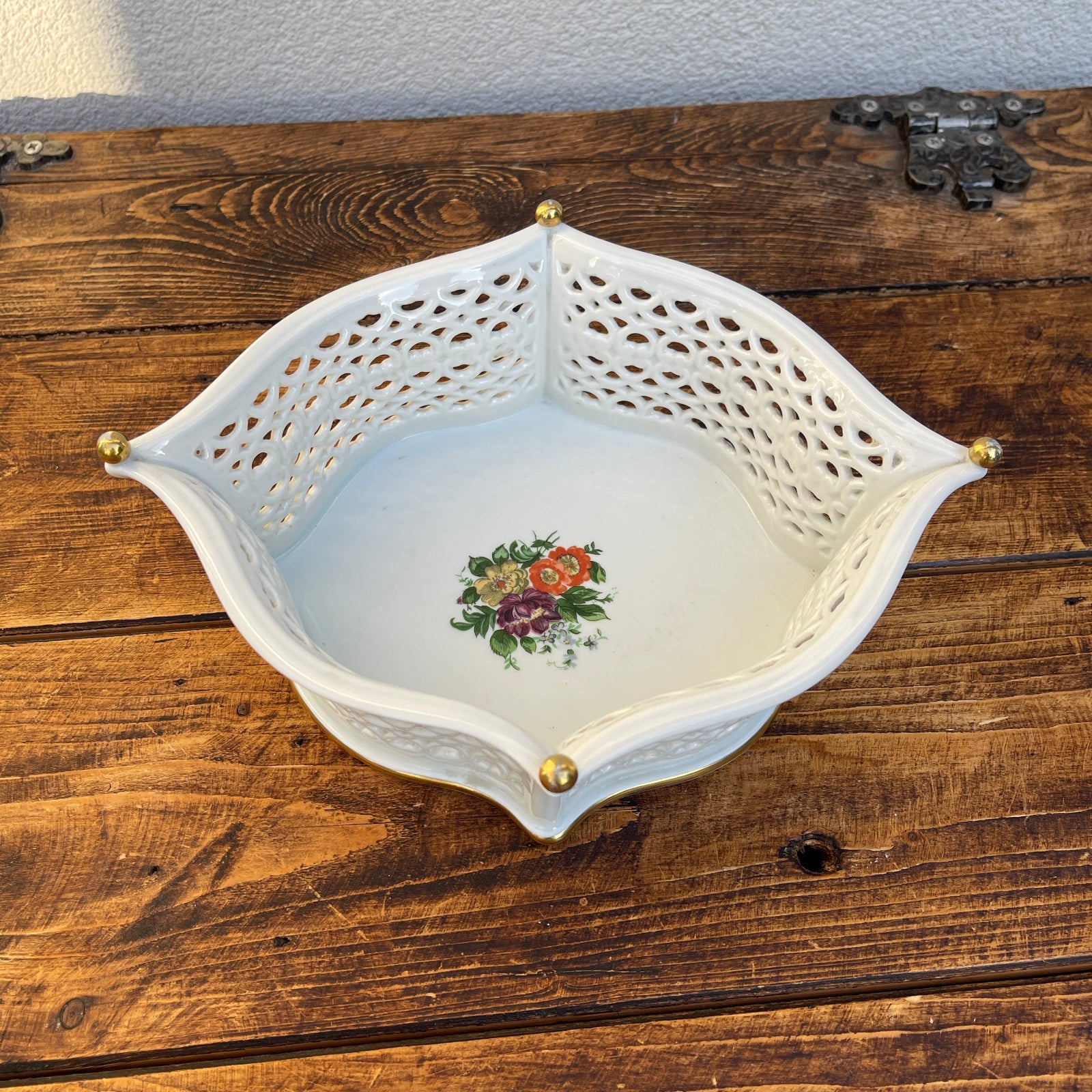 Decorative ceramic bowl with floral design on a wooden surface