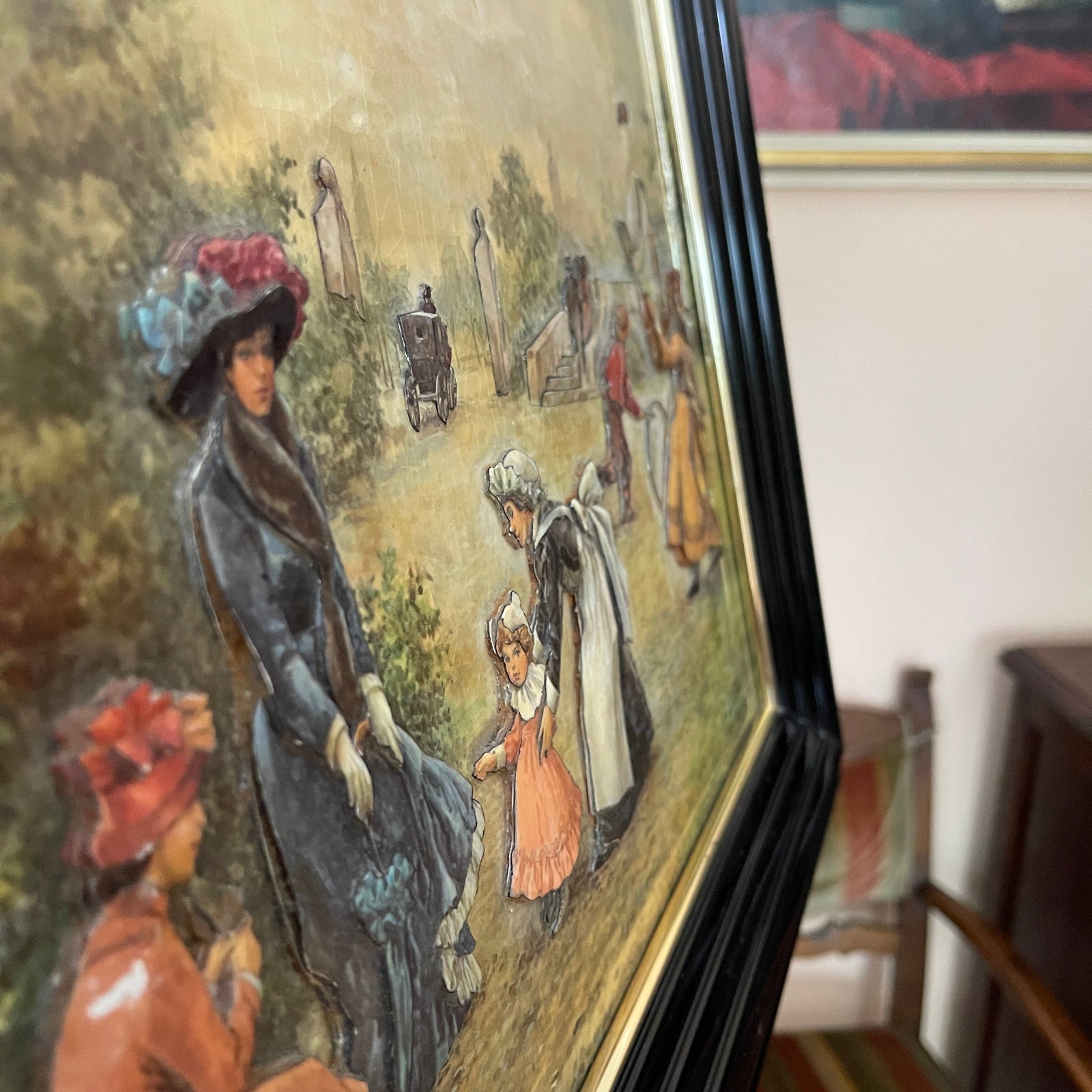 Vintage-style painting of a woman and child in a garden setting, with a chair and striped cushion in the background.