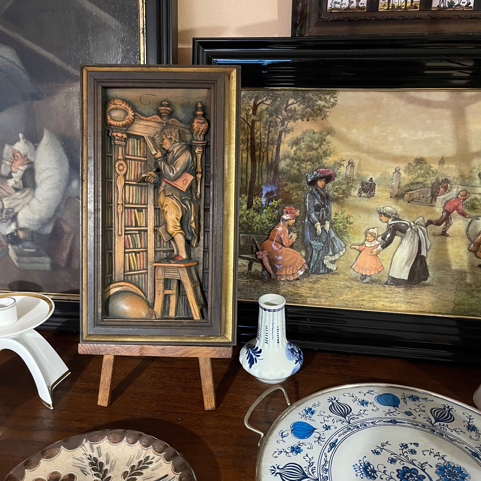 Decorative table setting with framed artworks and patterned plates.