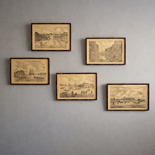 Five framed vintage-style cityscape prints on a gray wall.