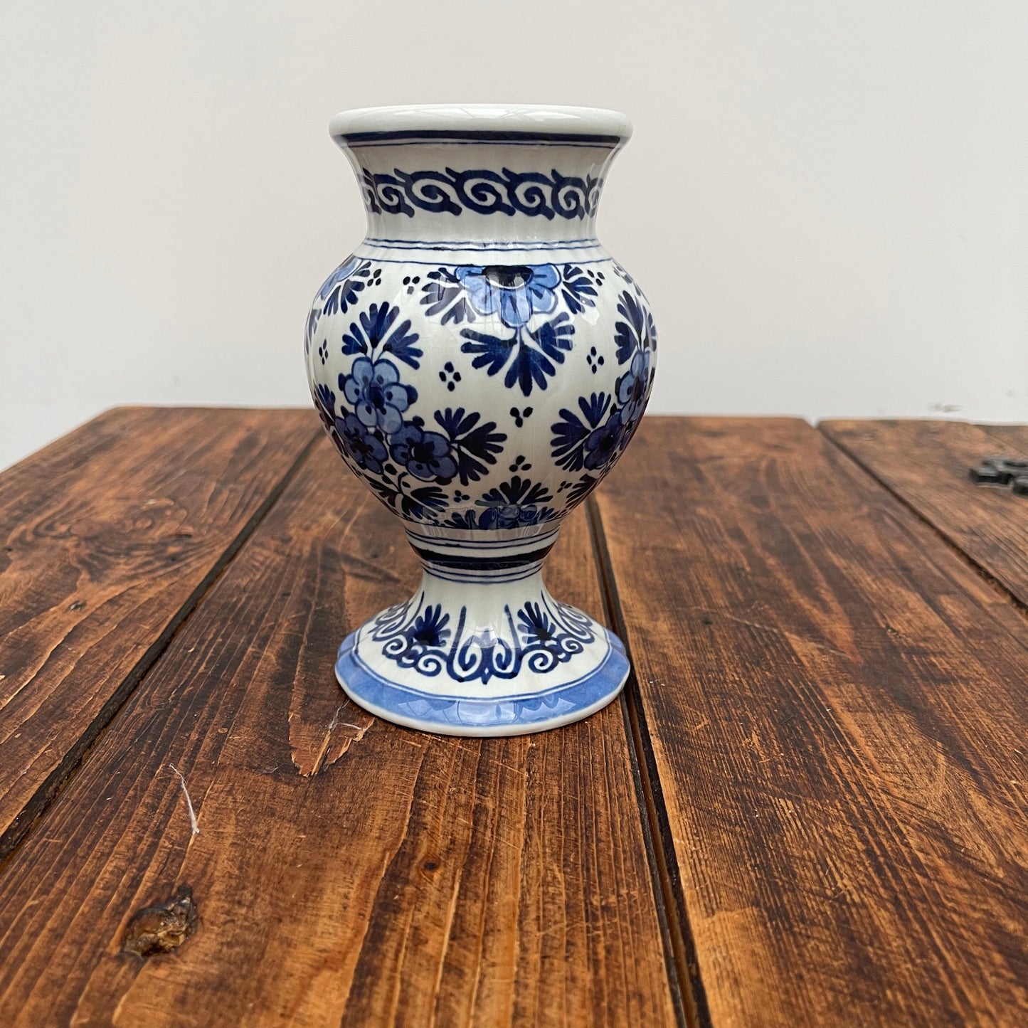 Blue and white floral-patterned vase on a wooden table