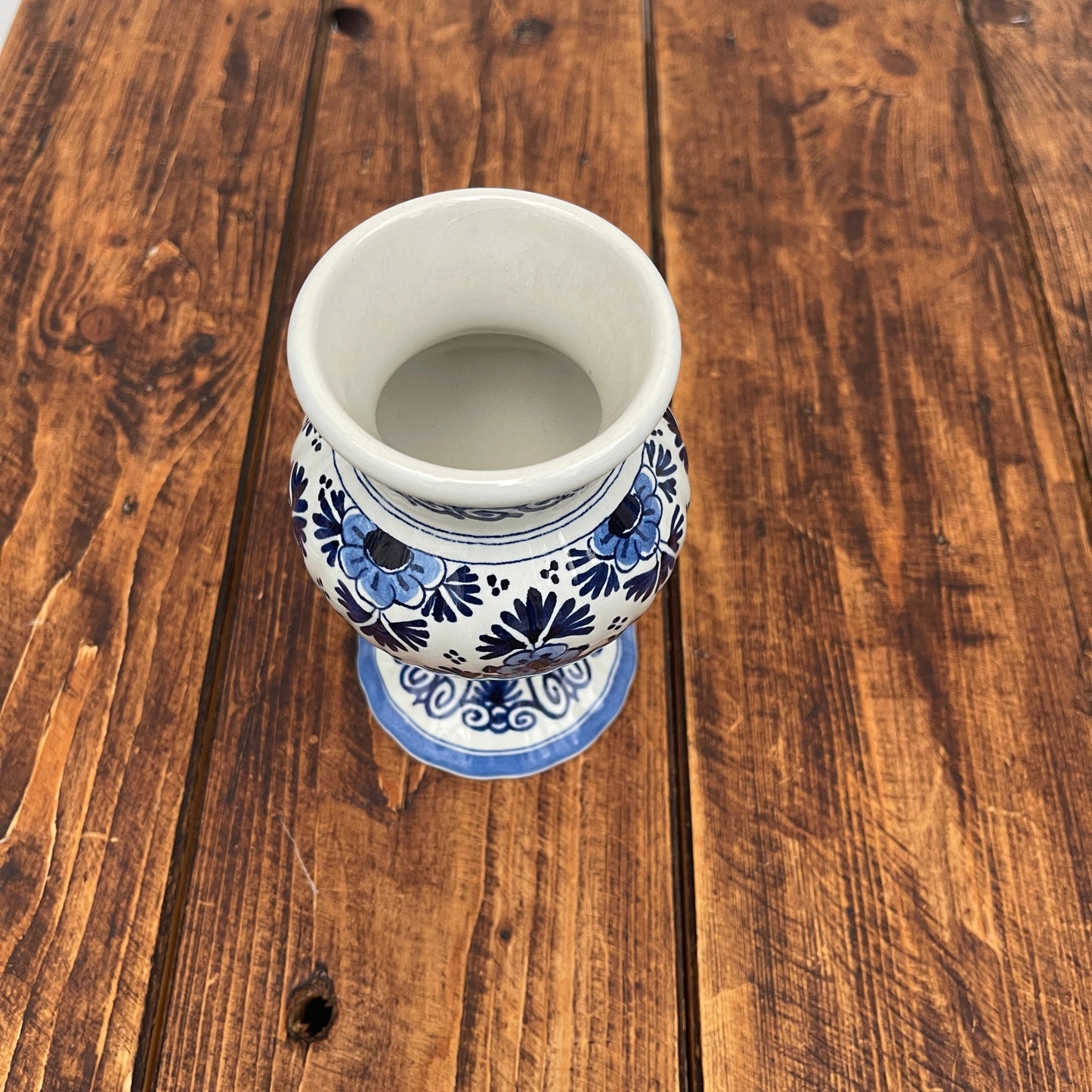 Ceramic vase with blue floral patterns on a wooden surface