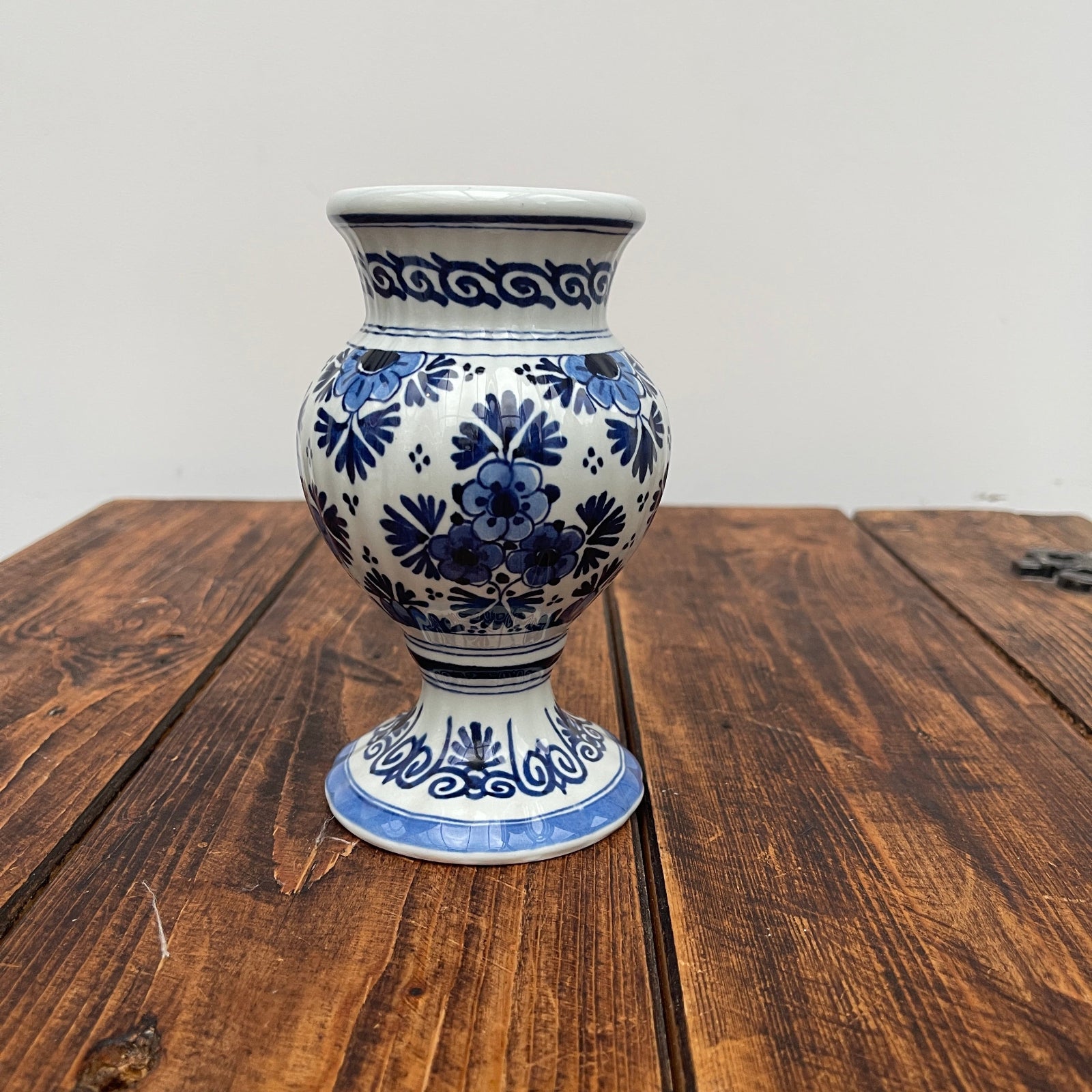 Ceramic vase with blue floral patterns on a wooden surface