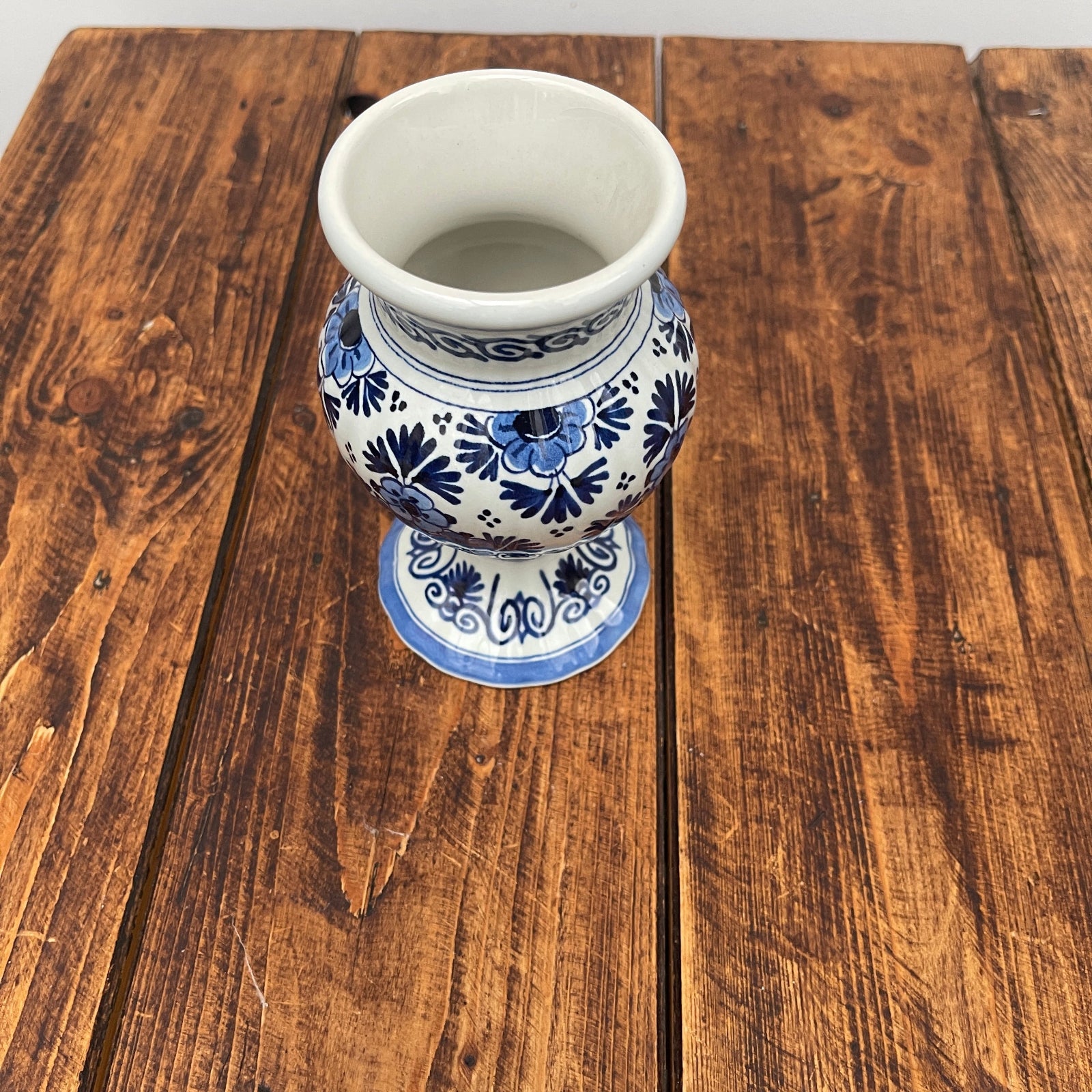 Blue and white ceramic vase on a wooden surface