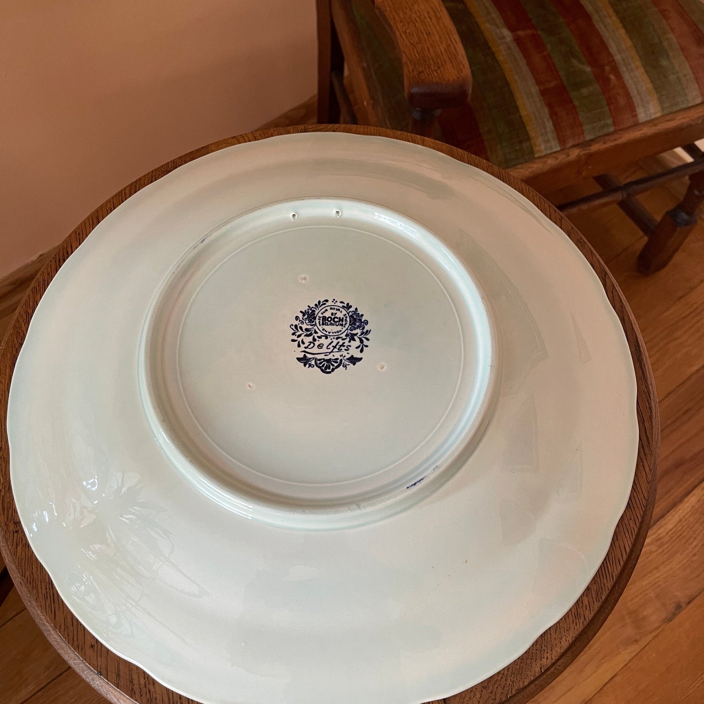 White plate with a decorative logo on a wooden surface
