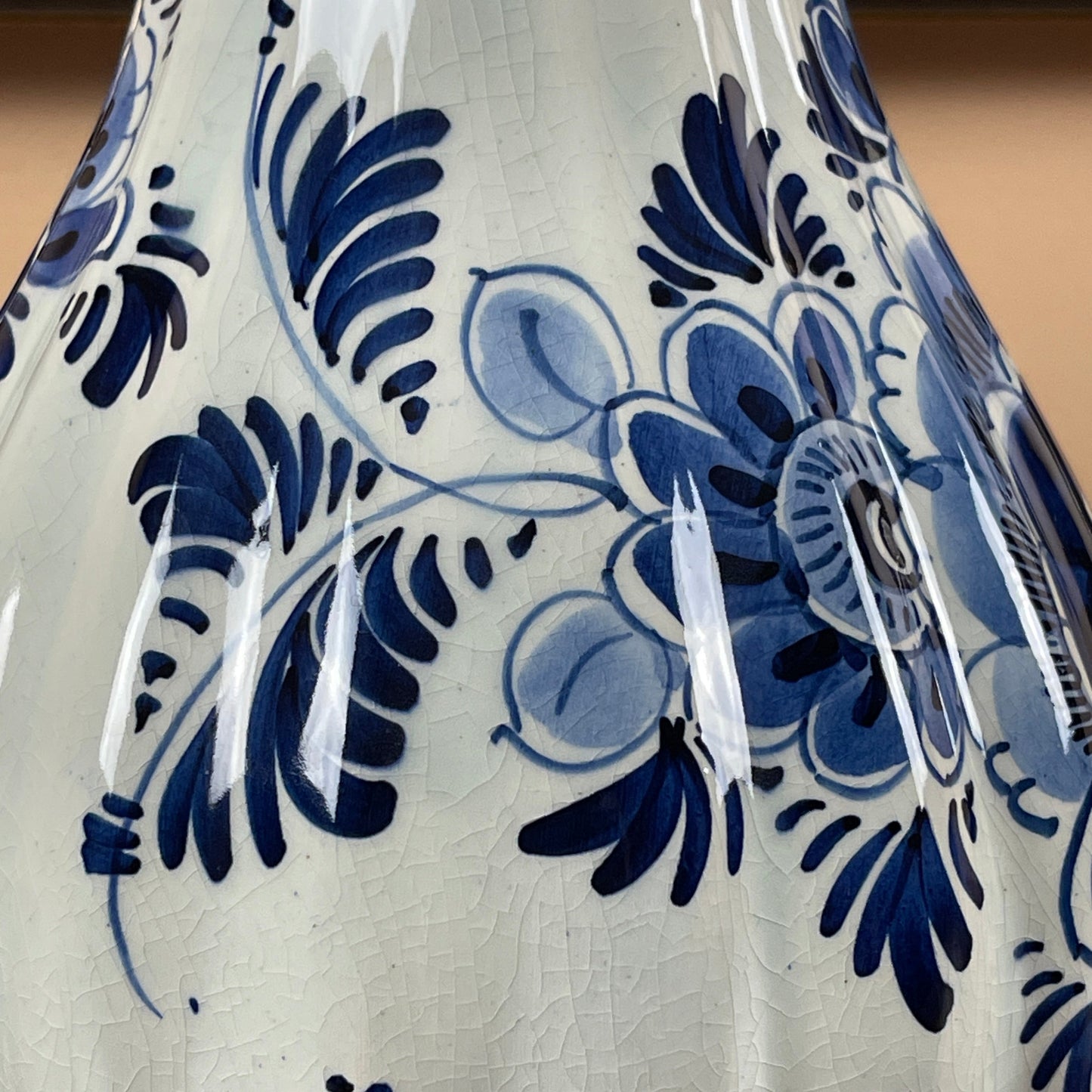 Close-up of a ceramic vase with blue floral patterns on a white background