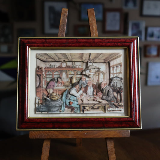 A framed 3D illustration of a tavern scene created by the Dutch artist Anton Pieck, showing a group of people seated in a tavern, interacting and drinking.