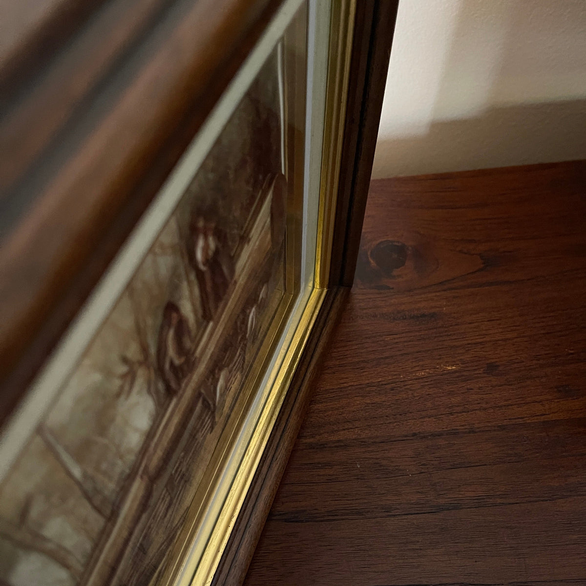 Close-up of a wooden surface with a decorative frame corner.