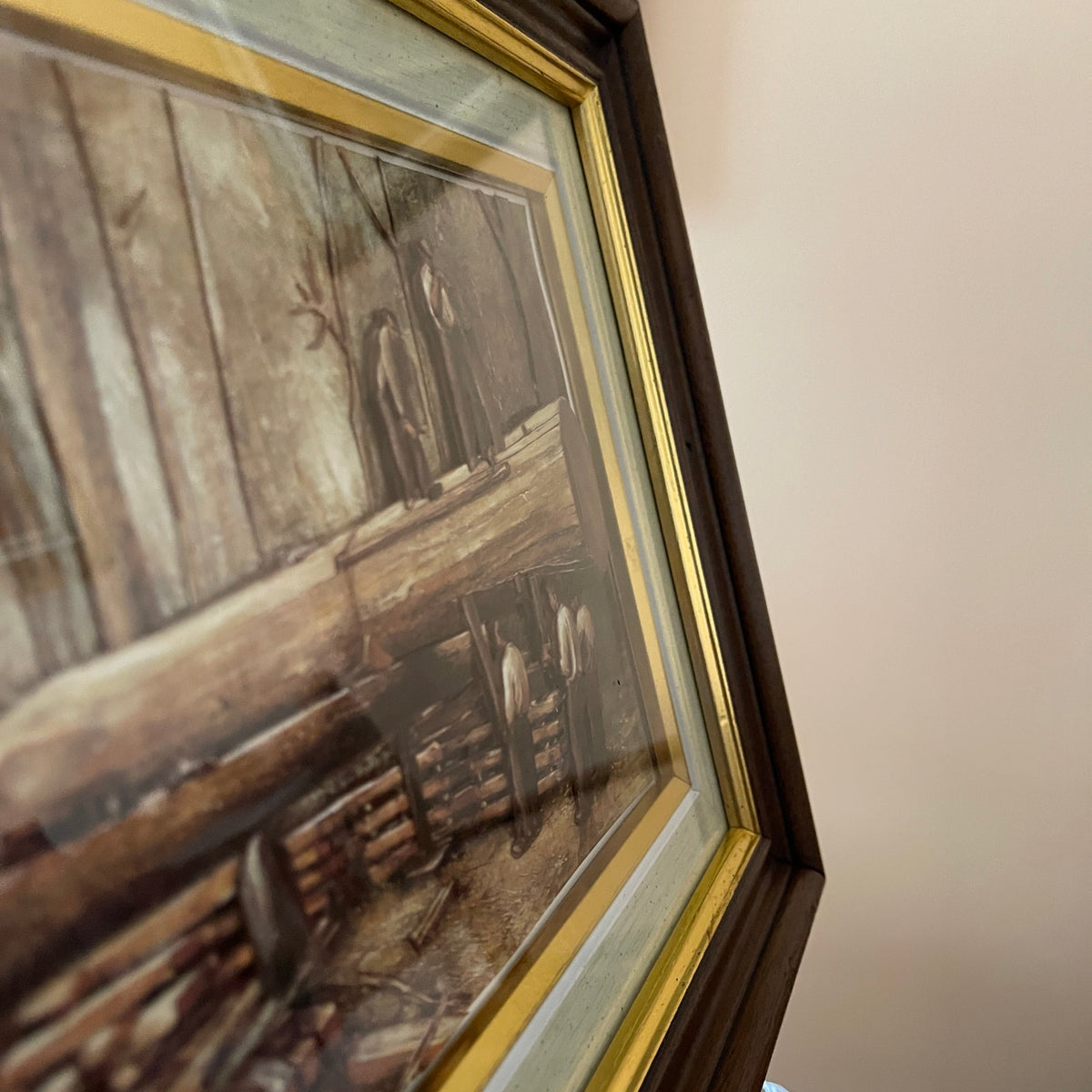 Framed painting of a rustic interior scene with wooden elements.
