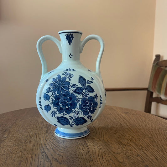 White vase with blue floral patterns on a wooden table