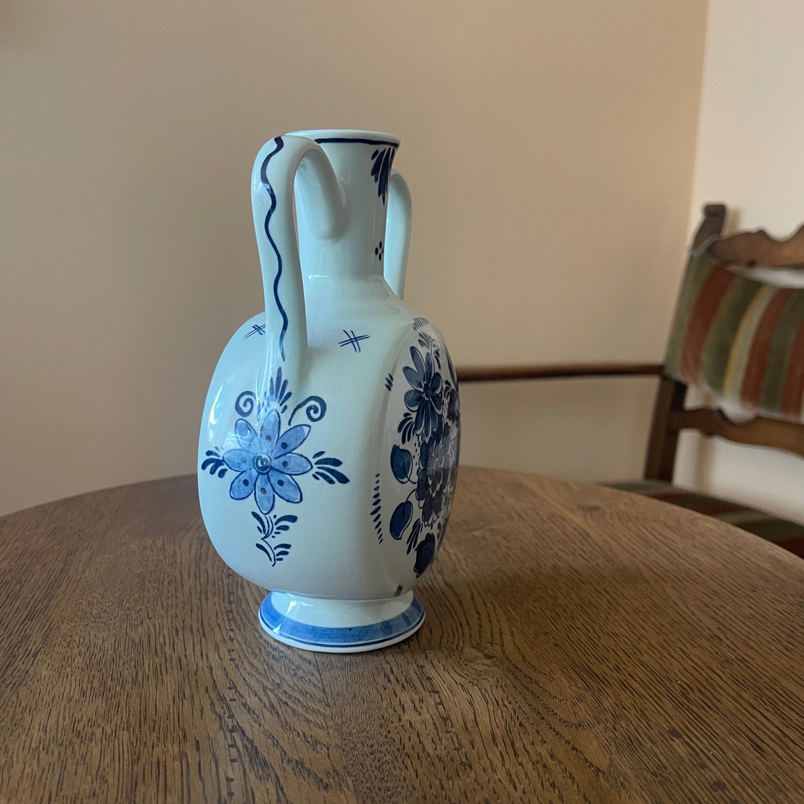 White vase with blue floral patterns on a wooden table