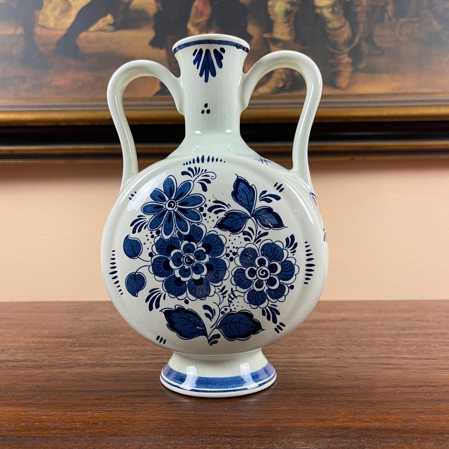 White vase with blue floral patterns on a wooden surface