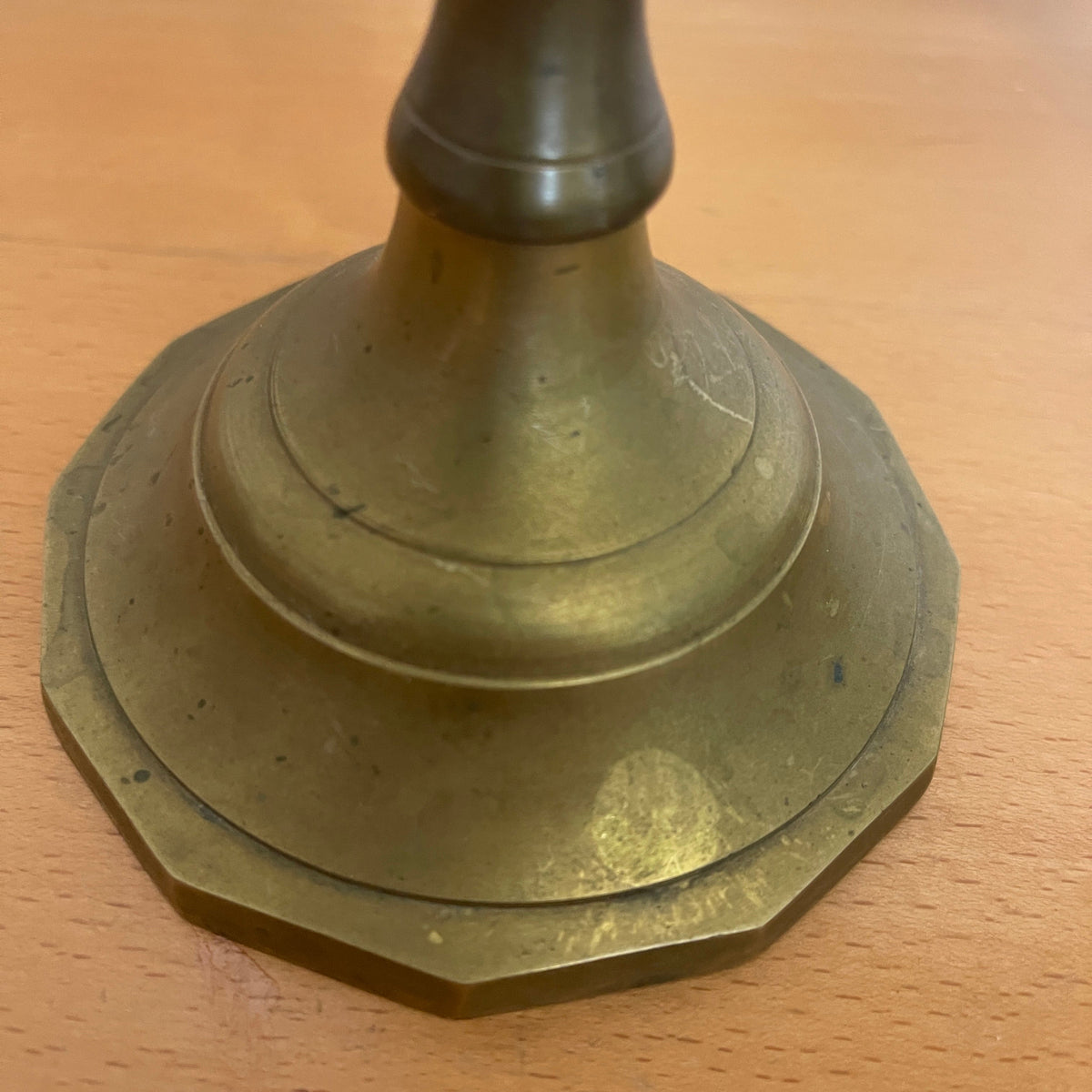 Brass candlestick on a wooden surface
