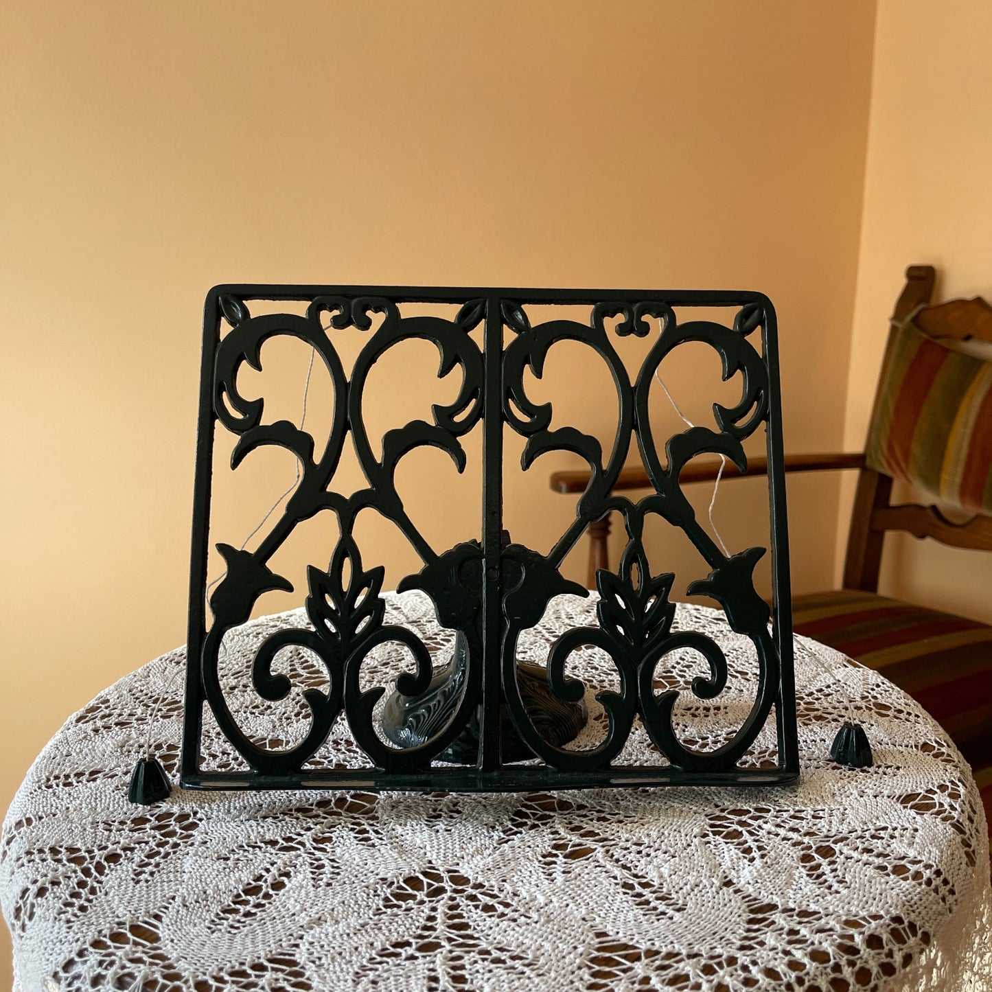 Decorative black metal screen on a table with a lace tablecloth