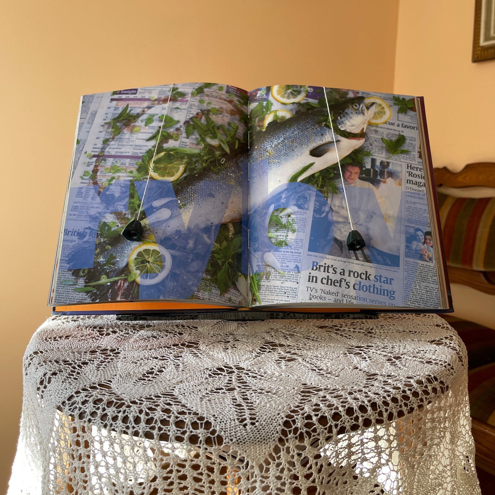 Open magazine on a lace tablecloth with a neutral background
