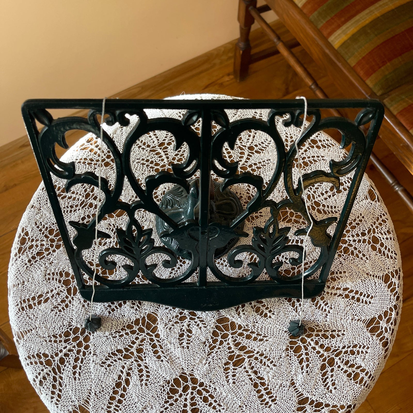 Decorative black metal stand on a lace tablecloth
